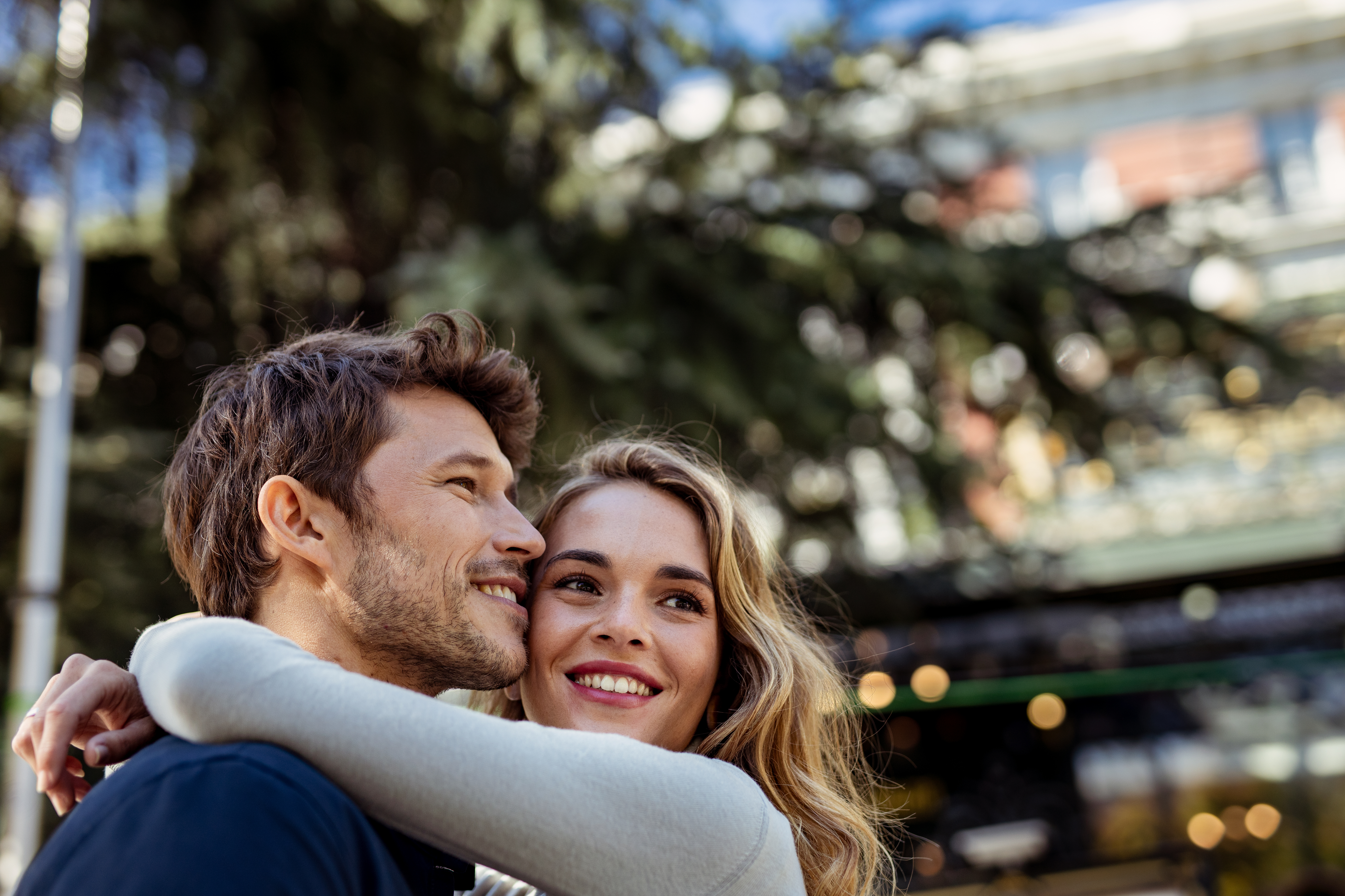 a man and woman hugging outside