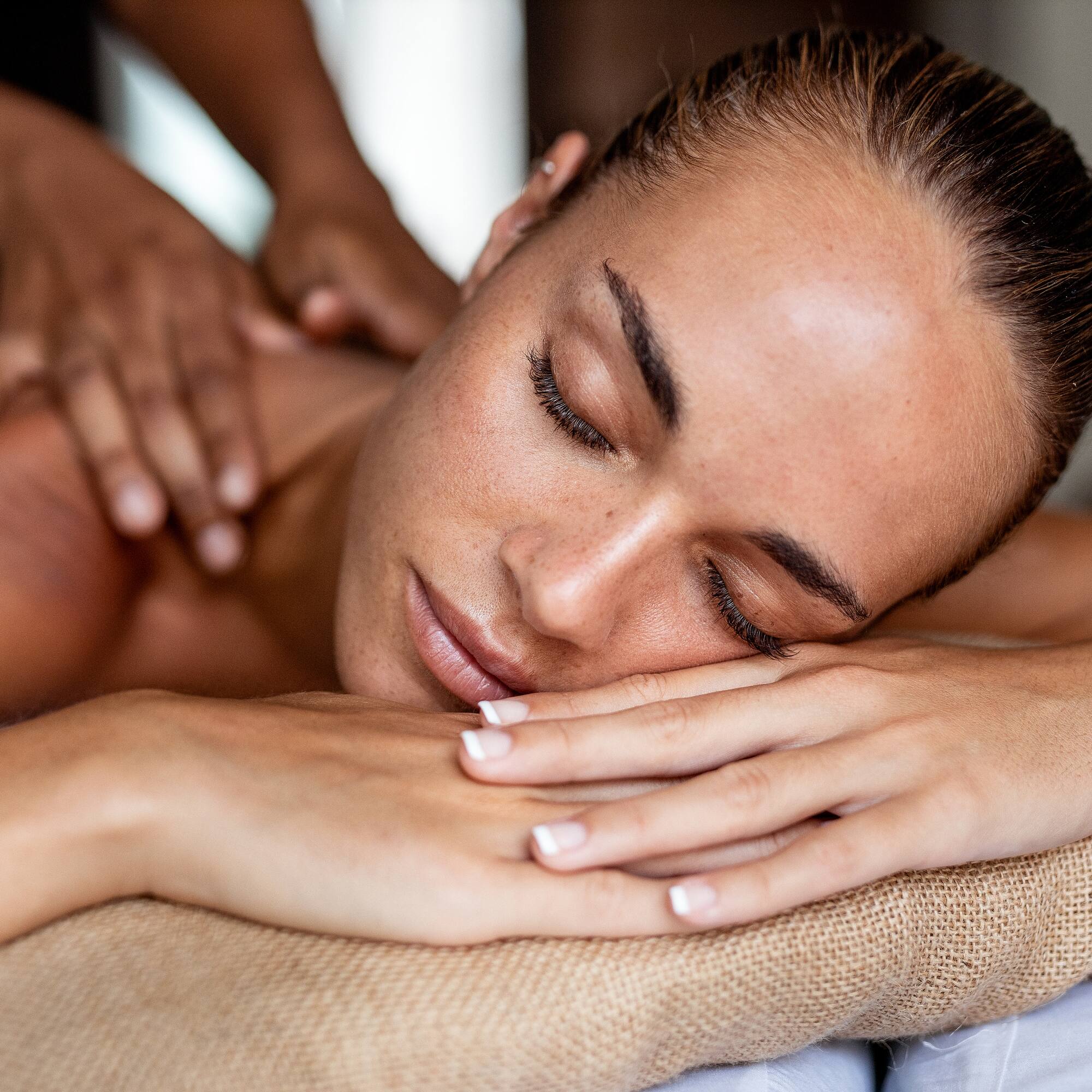 a woman lying down on a massage table