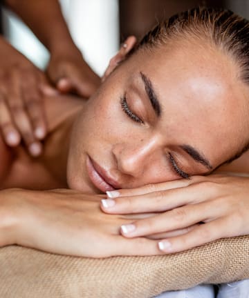 a woman lying down on a massage table