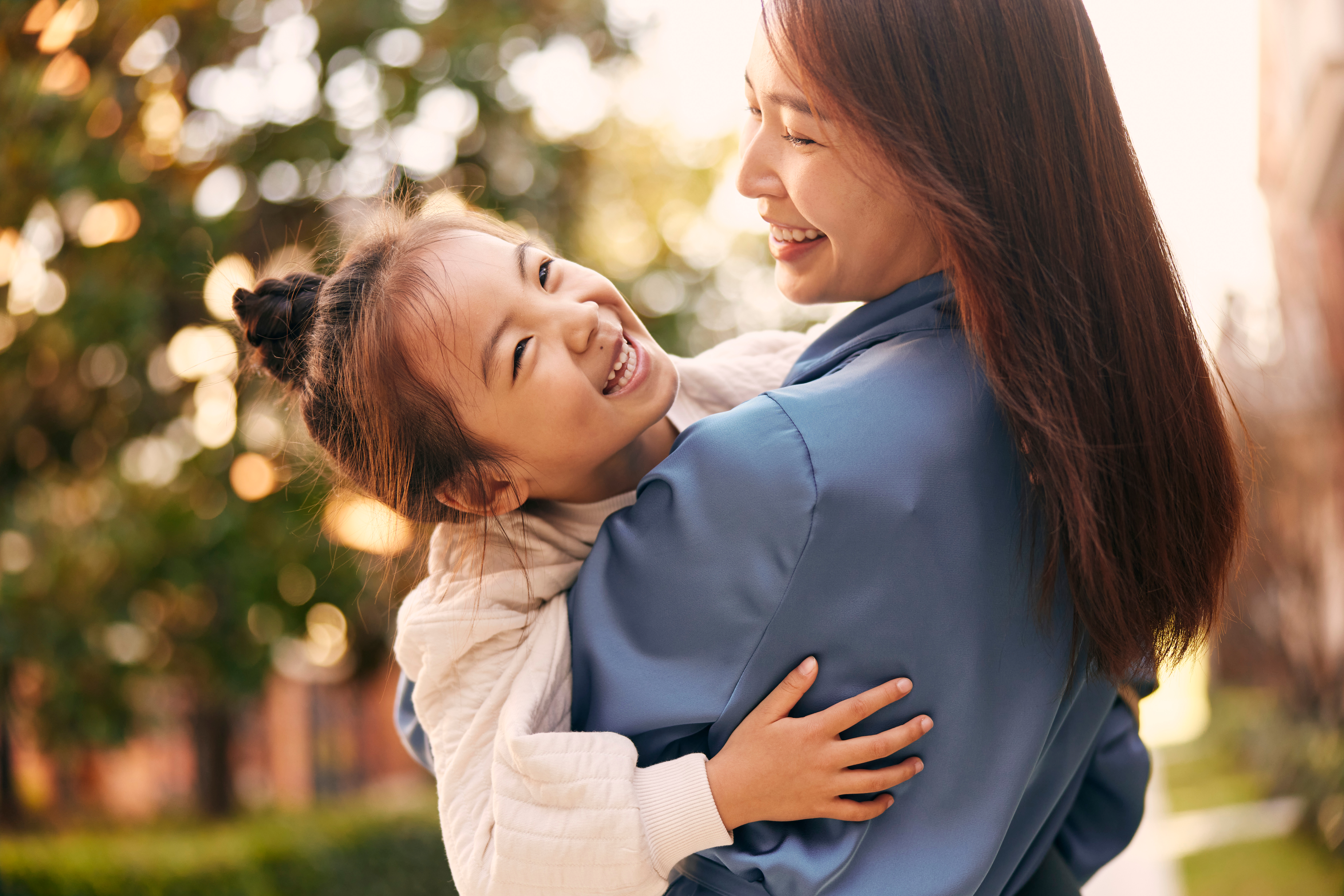 a woman and a girl hugging