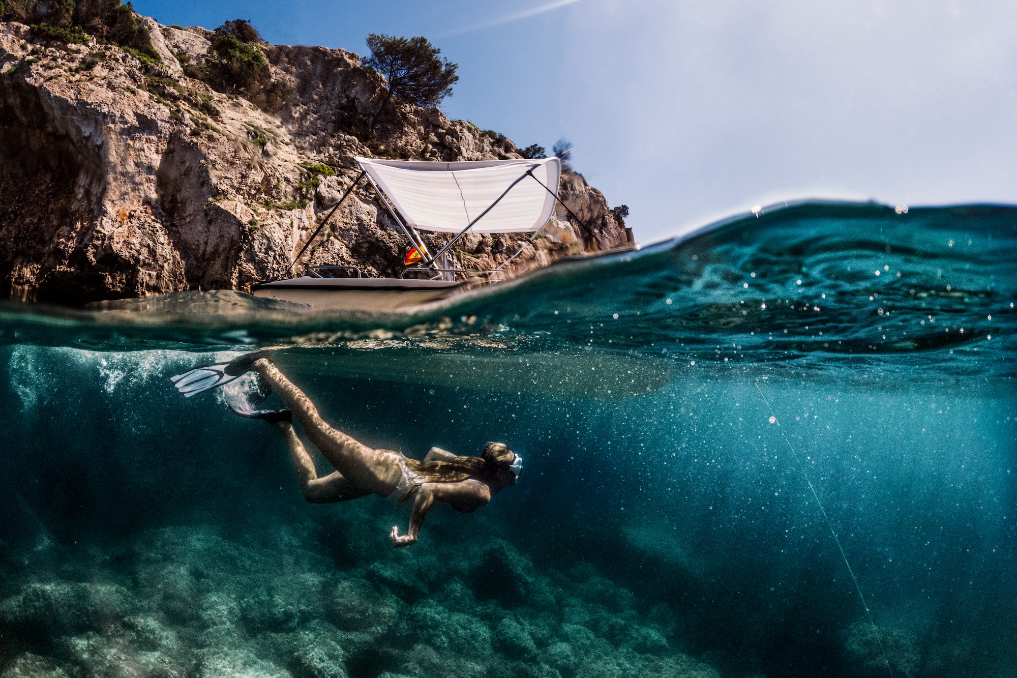 a woman swimming under water
