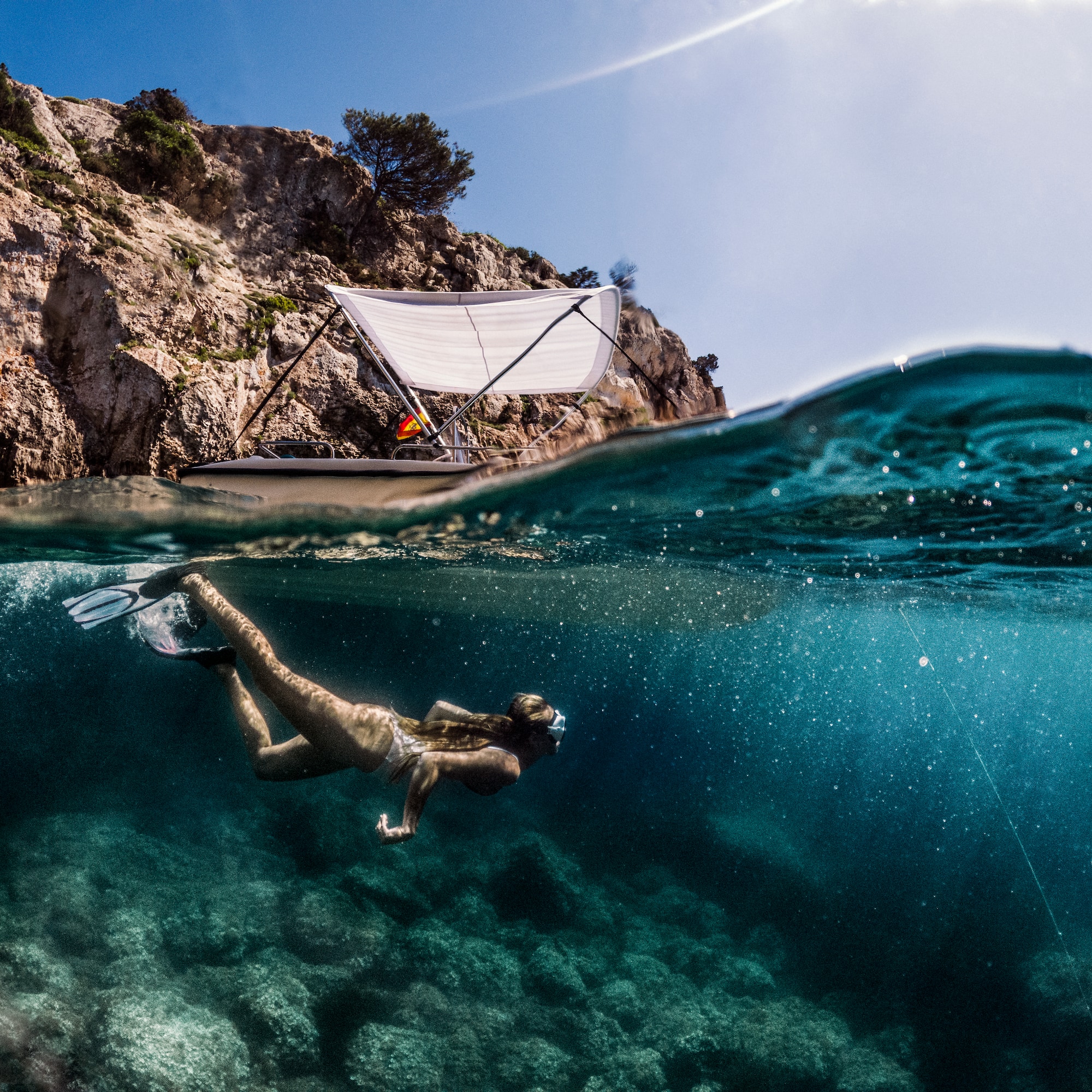 a woman swimming under water