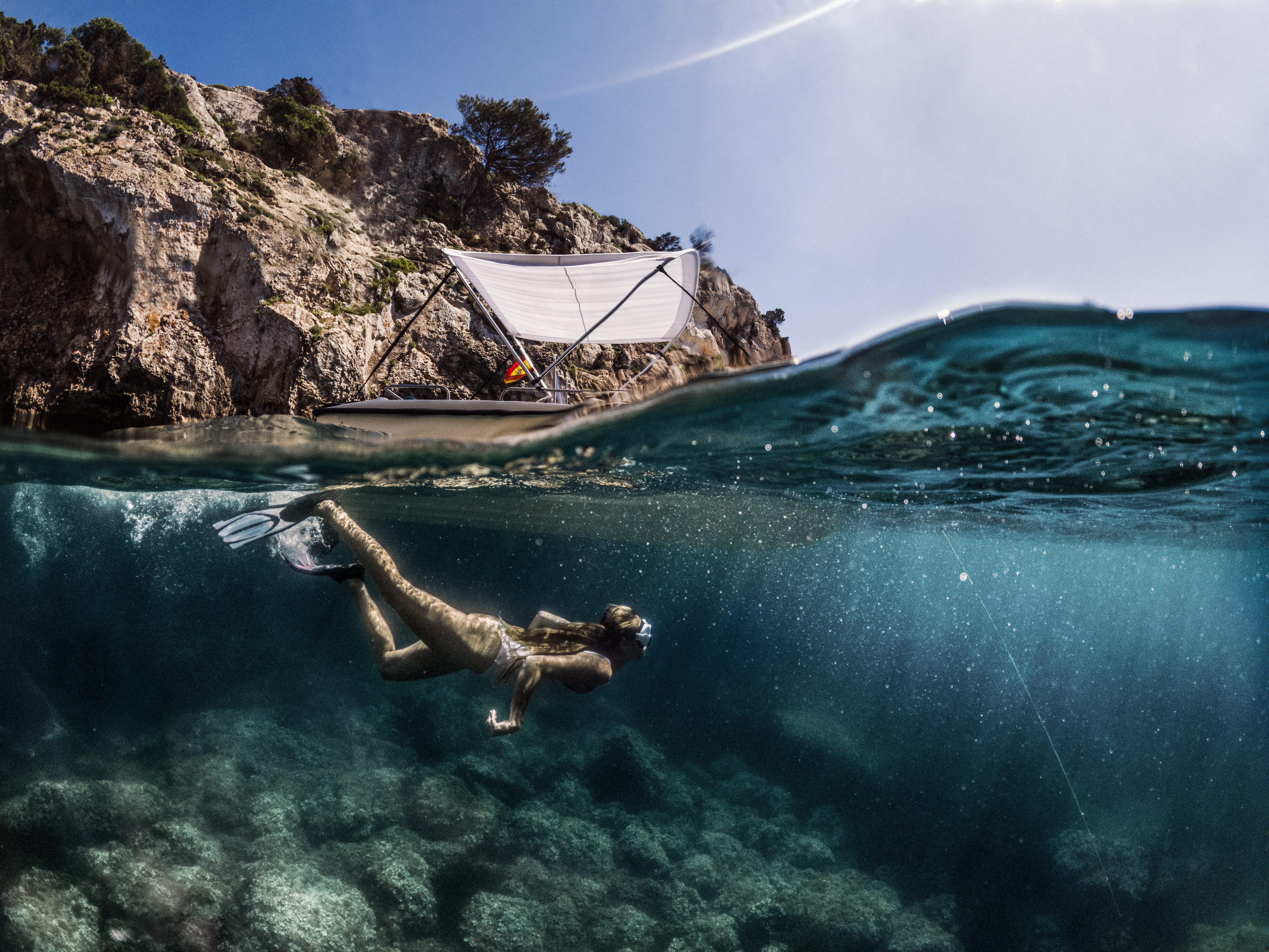 a woman swimming under water