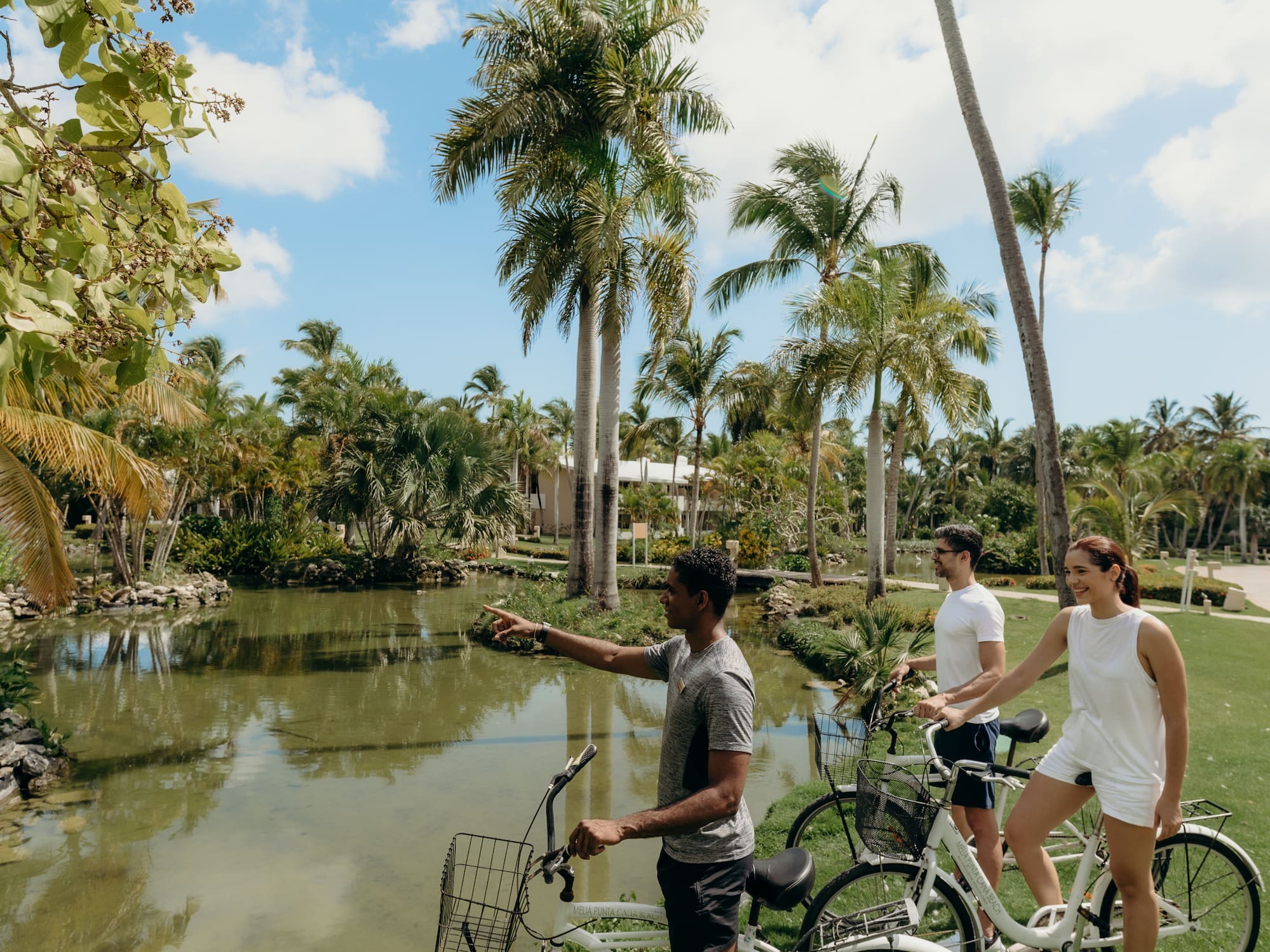 a group of people on bicycles by a pond