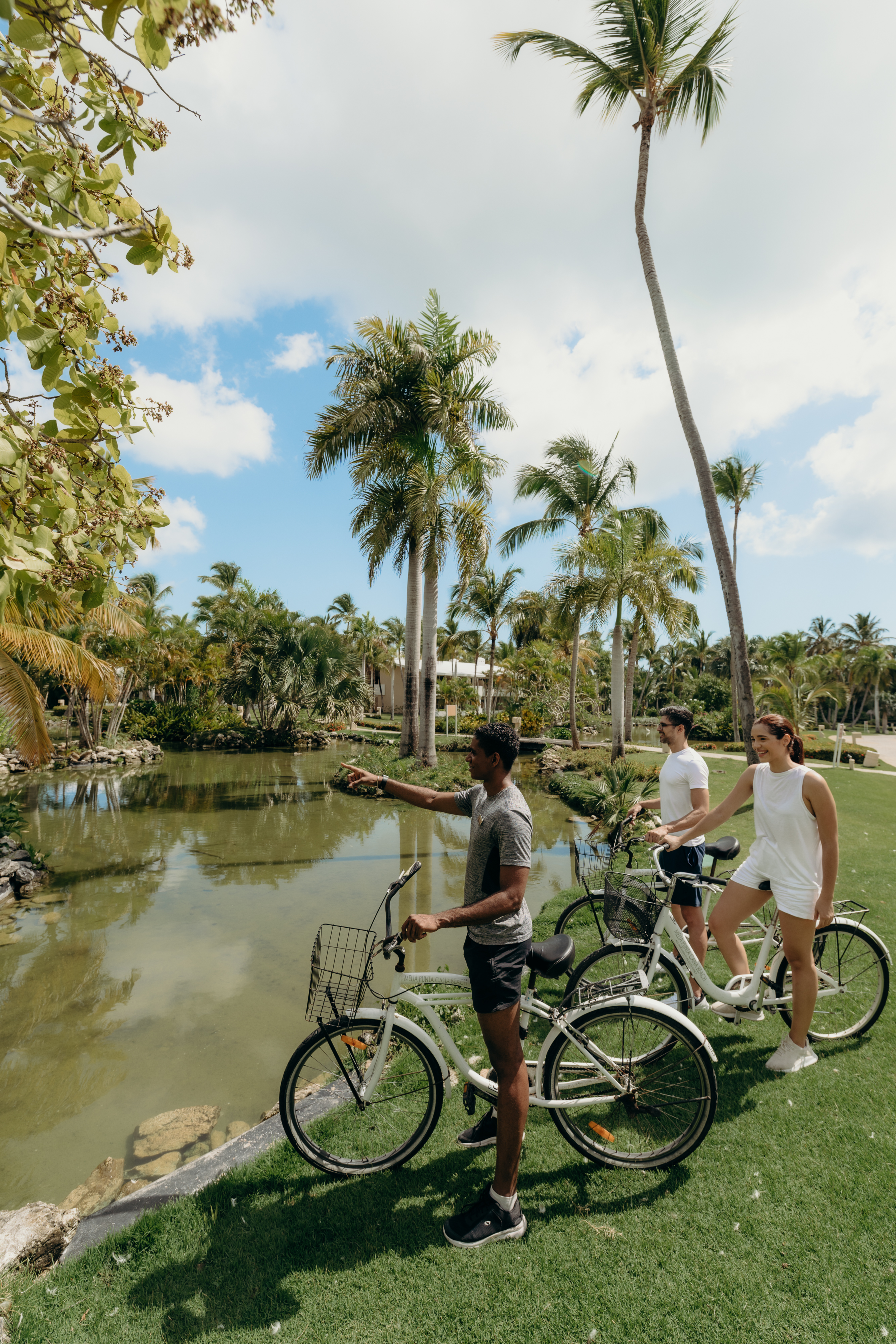 a group of people on bicycles by a pond