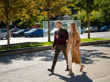 a man and woman walking on a street