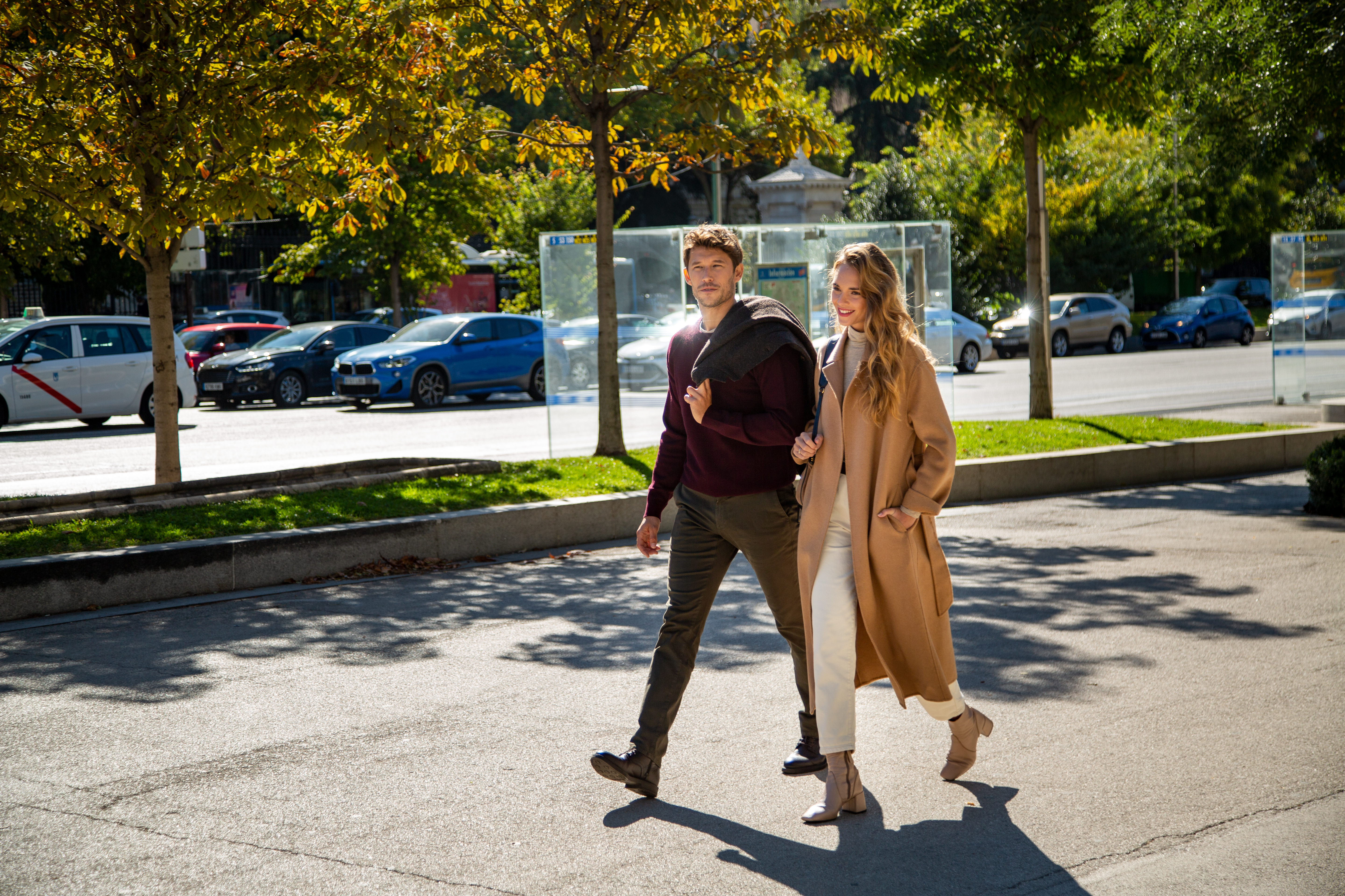 a man and woman walking on a street