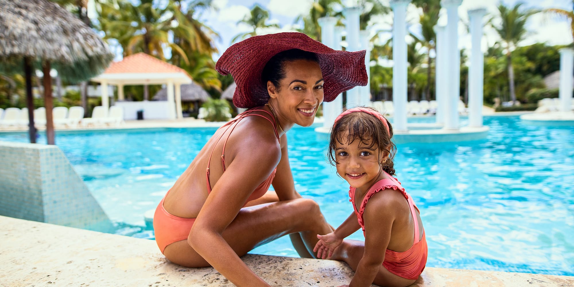 a woman and a girl in a pool