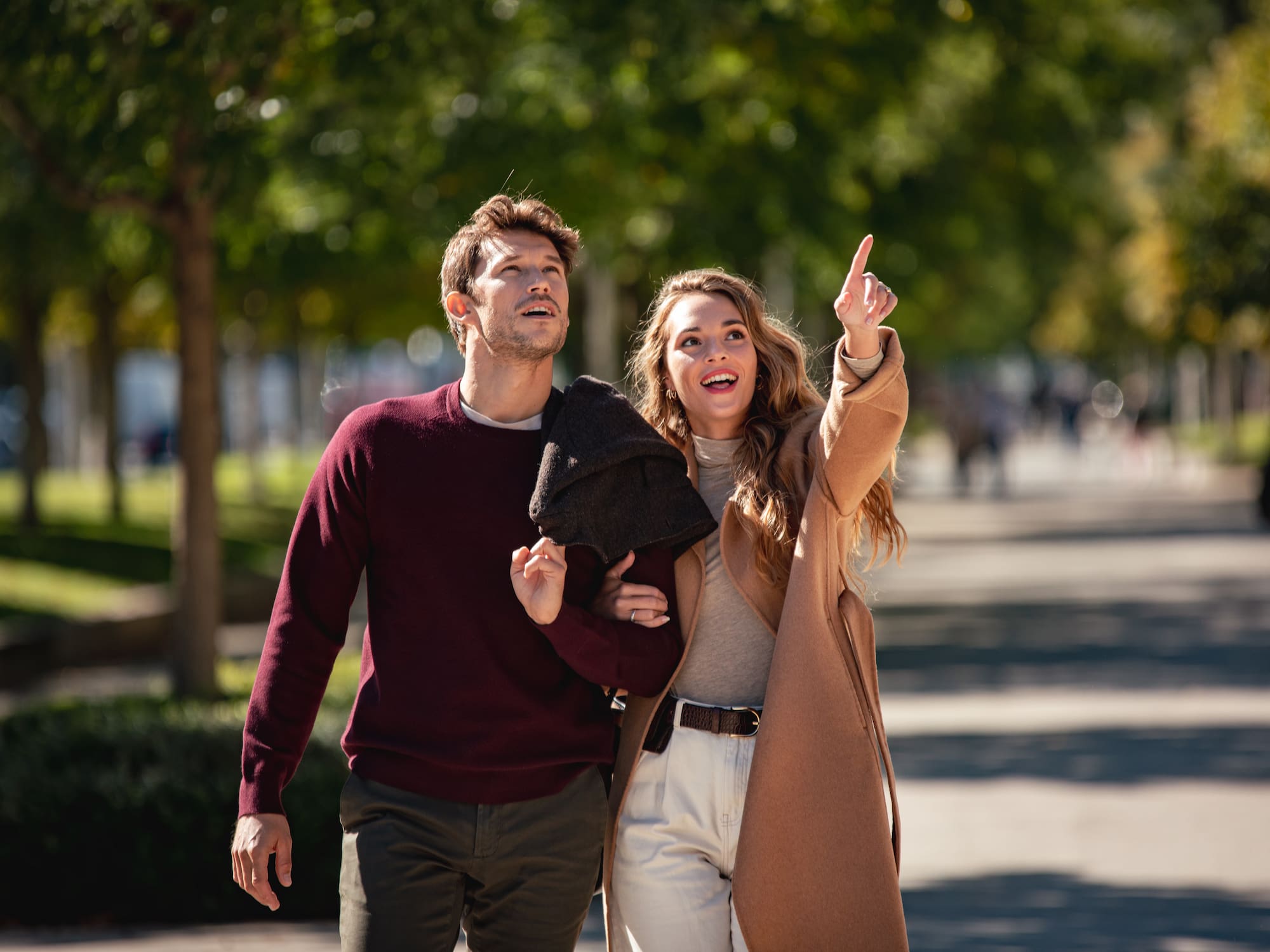 a man and woman walking down a sidewalk