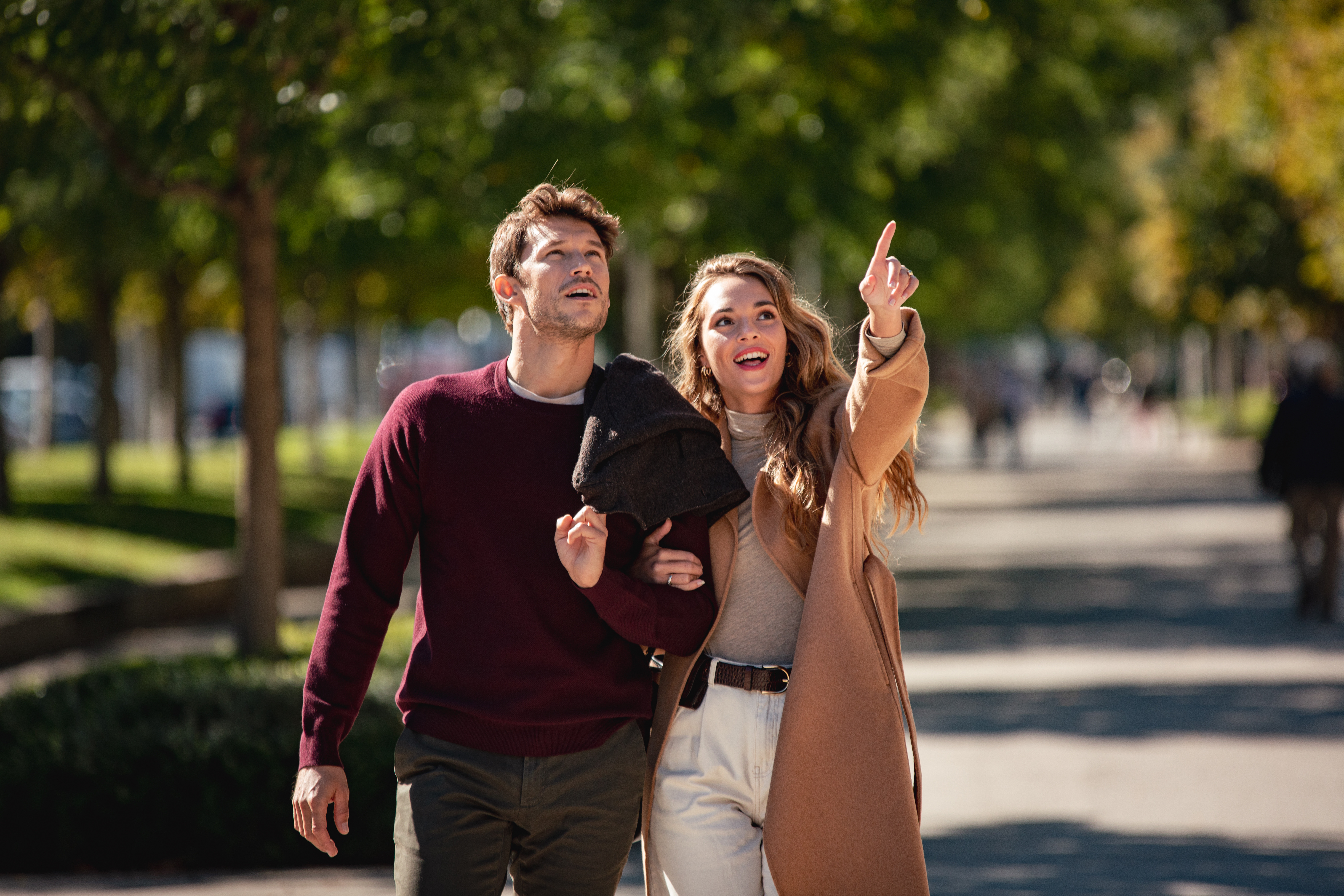 a man and woman walking down a sidewalk