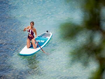 a woman on a paddle board