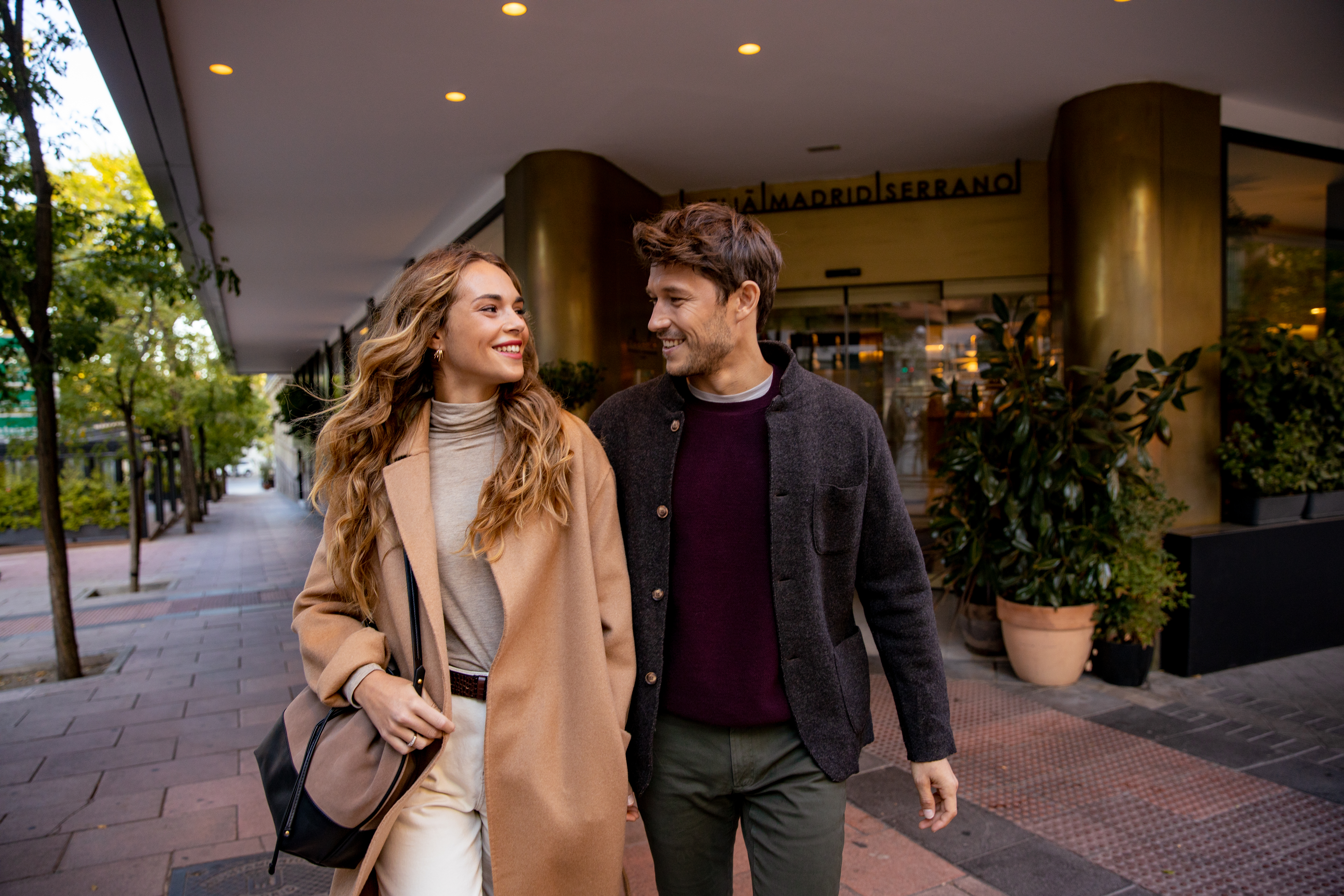 a man and woman walking down a sidewalk