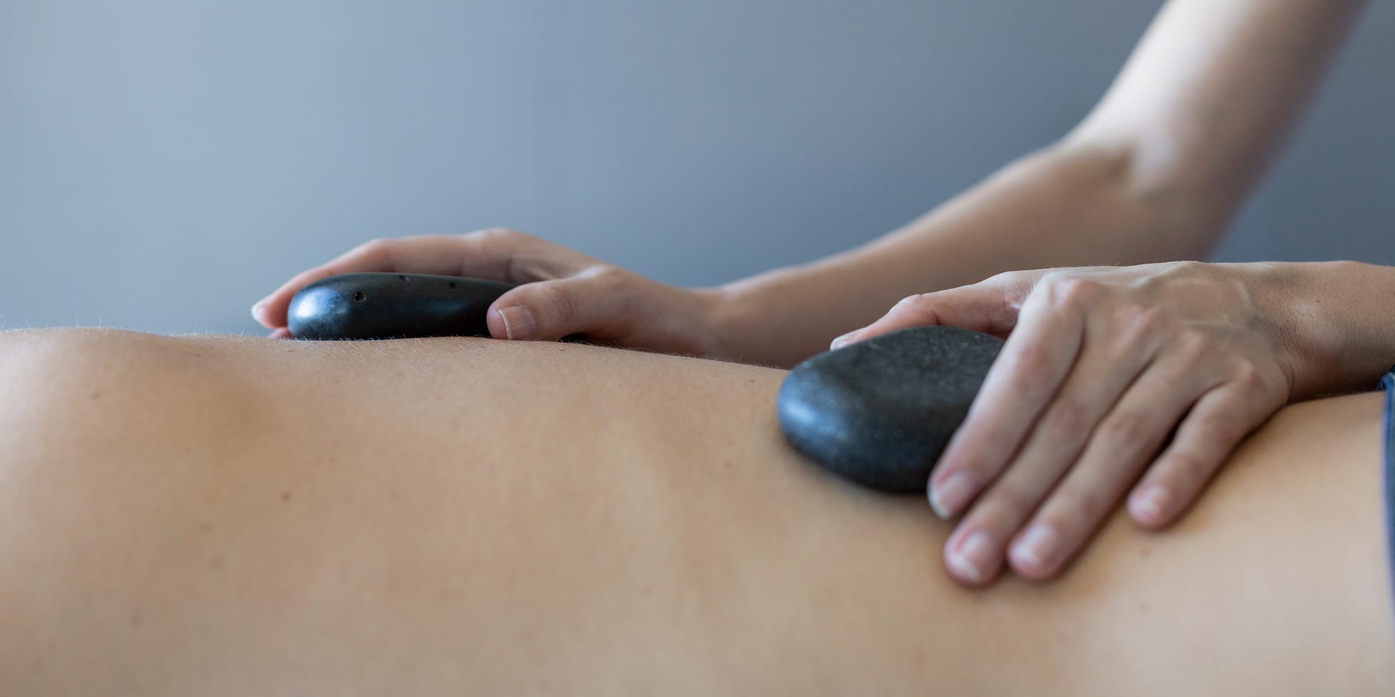 a person receiving a hot stone massage