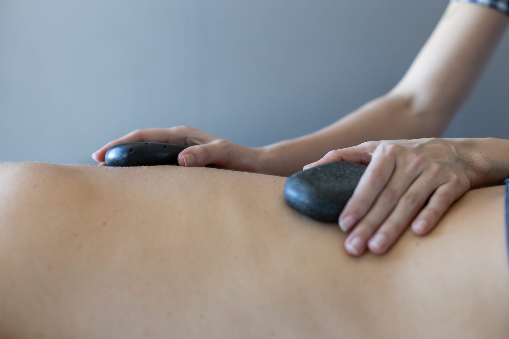 a person receiving a hot stone massage