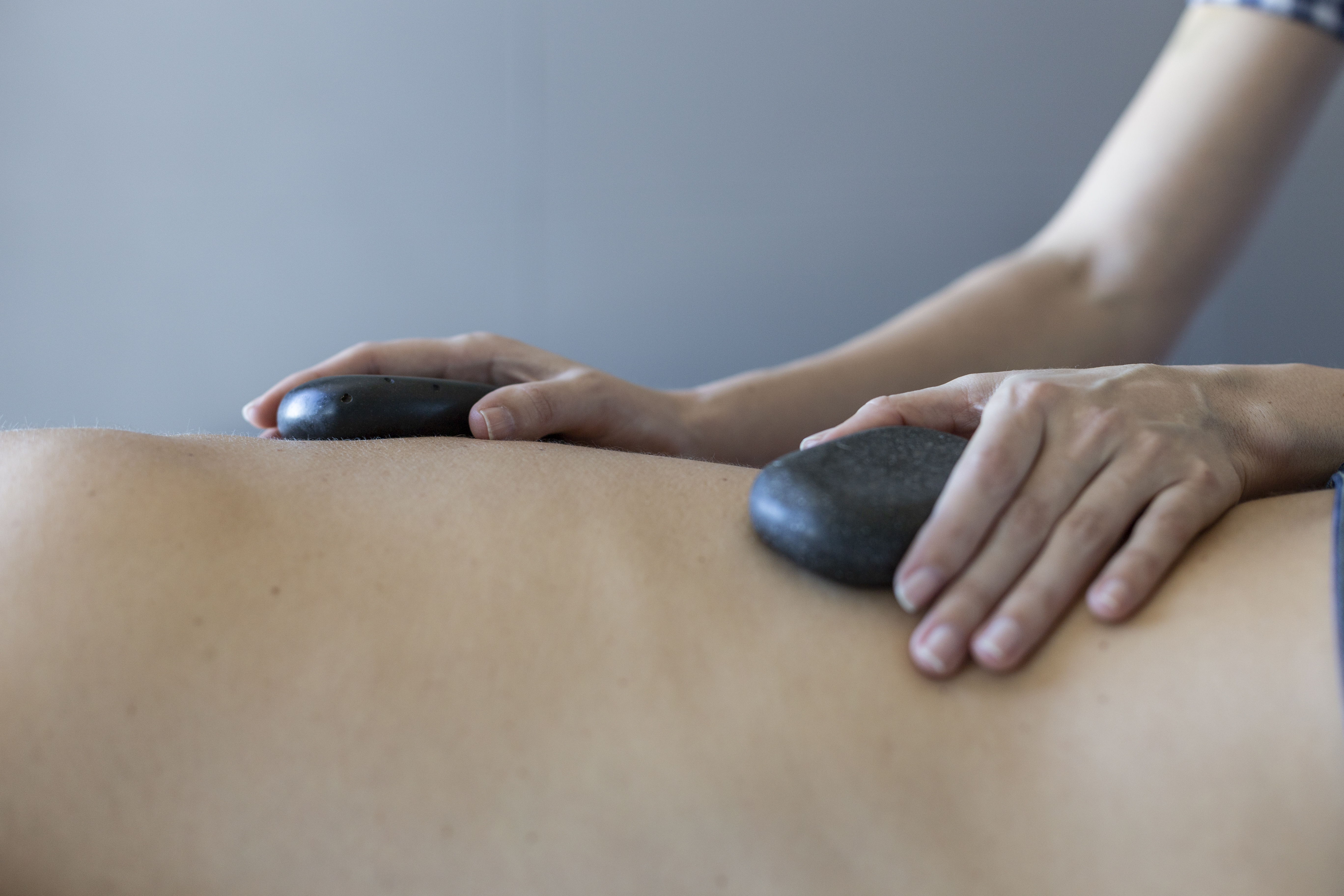 a person receiving a hot stone massage