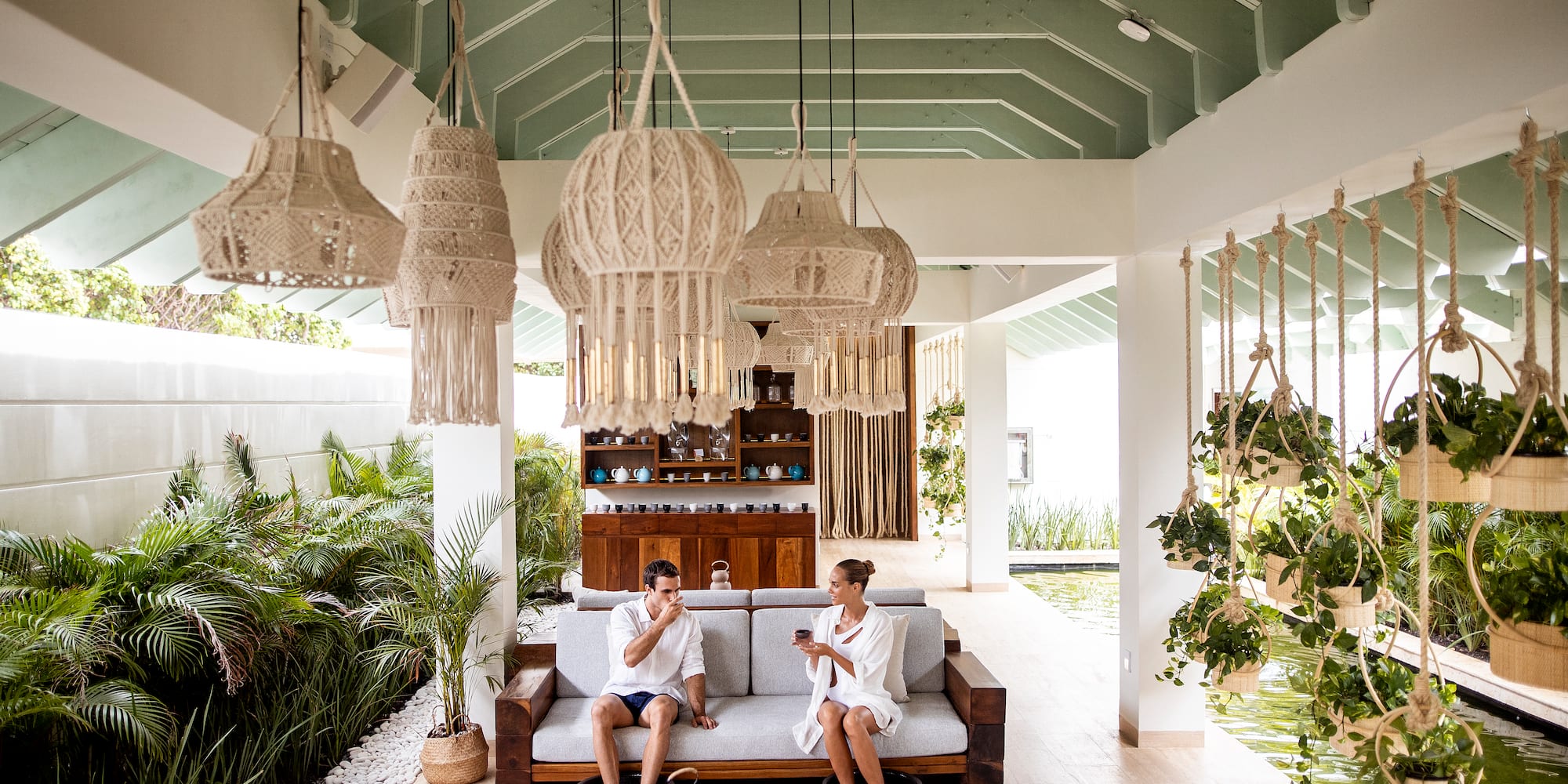 a couple of people sitting on a couch in a room with lights