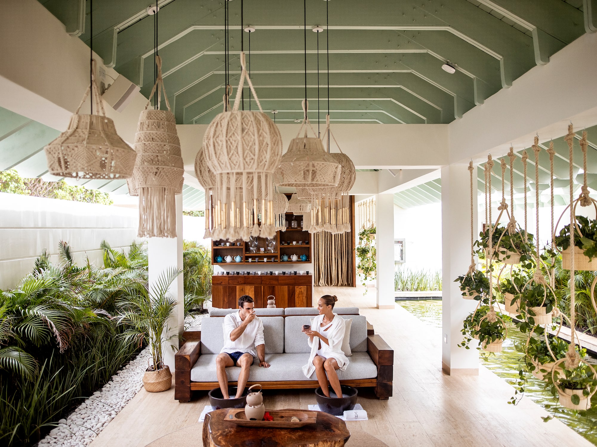 a couple of people sitting on a couch in a room with lights