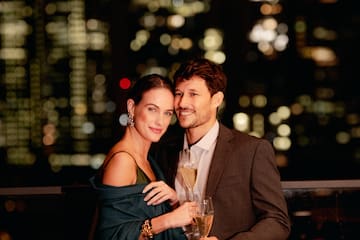 a man and woman holding glasses of champagne