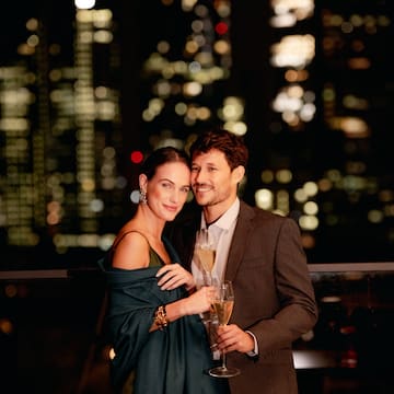 a man and woman holding glasses of champagne