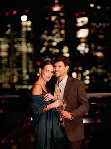 a man and woman holding glasses of champagne