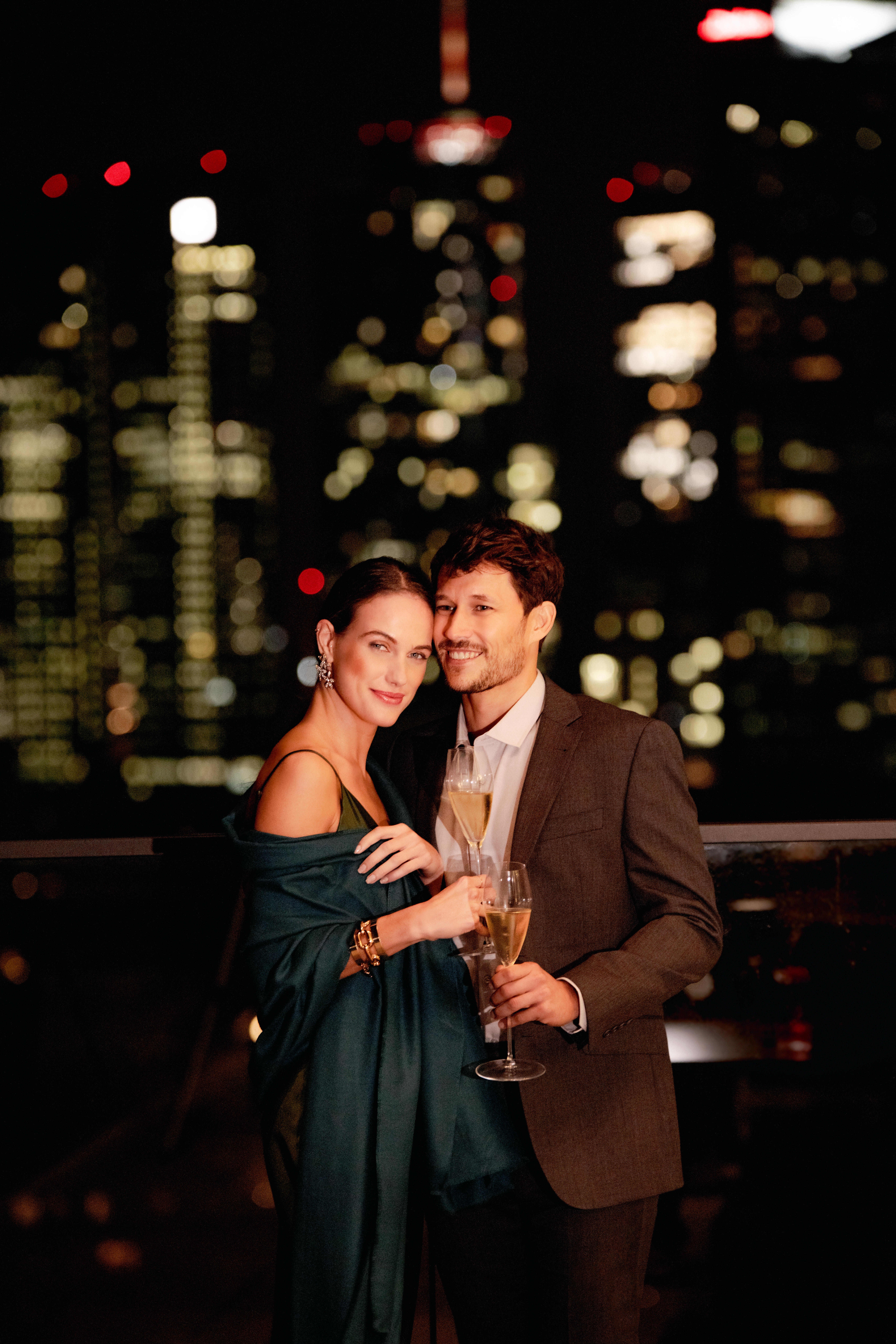 a man and woman holding glasses of champagne