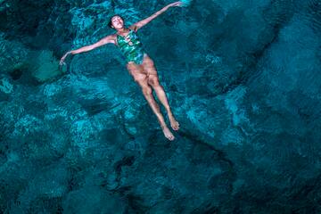 a woman floating in a body of water