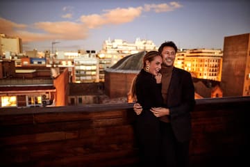 a man and woman hugging on a balcony
