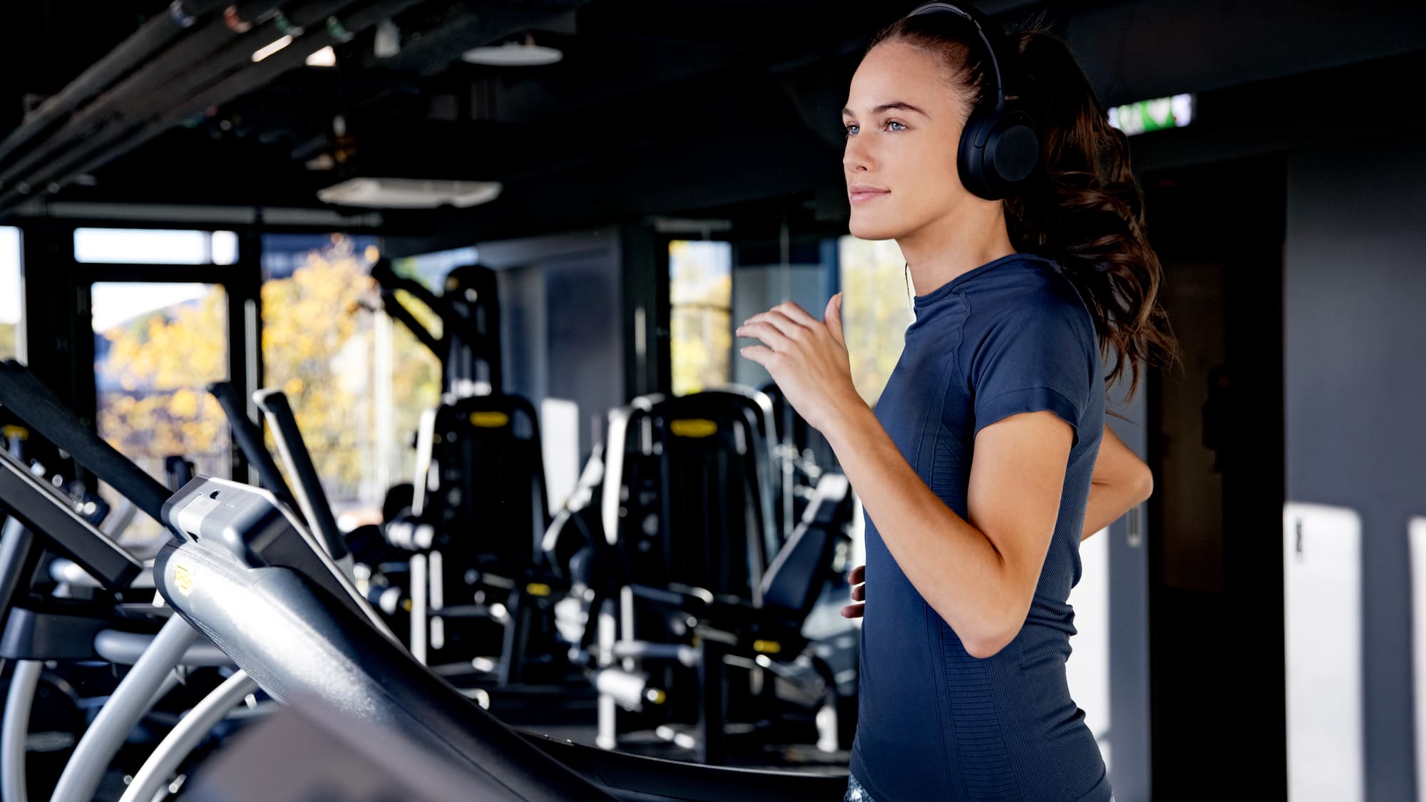 a woman running on a treadmill