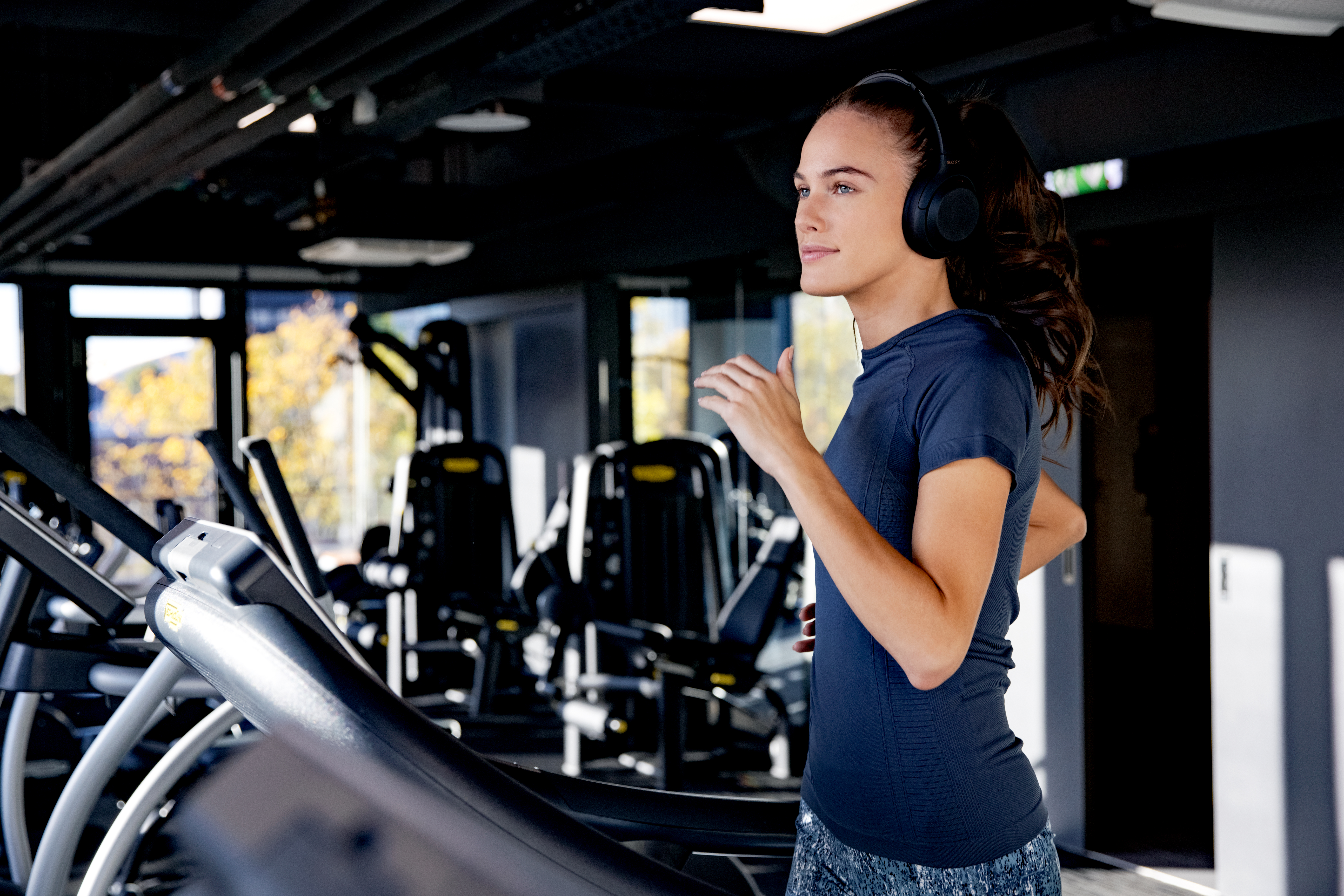 a woman running on a treadmill