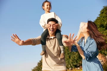 a man carrying a child on his shoulders