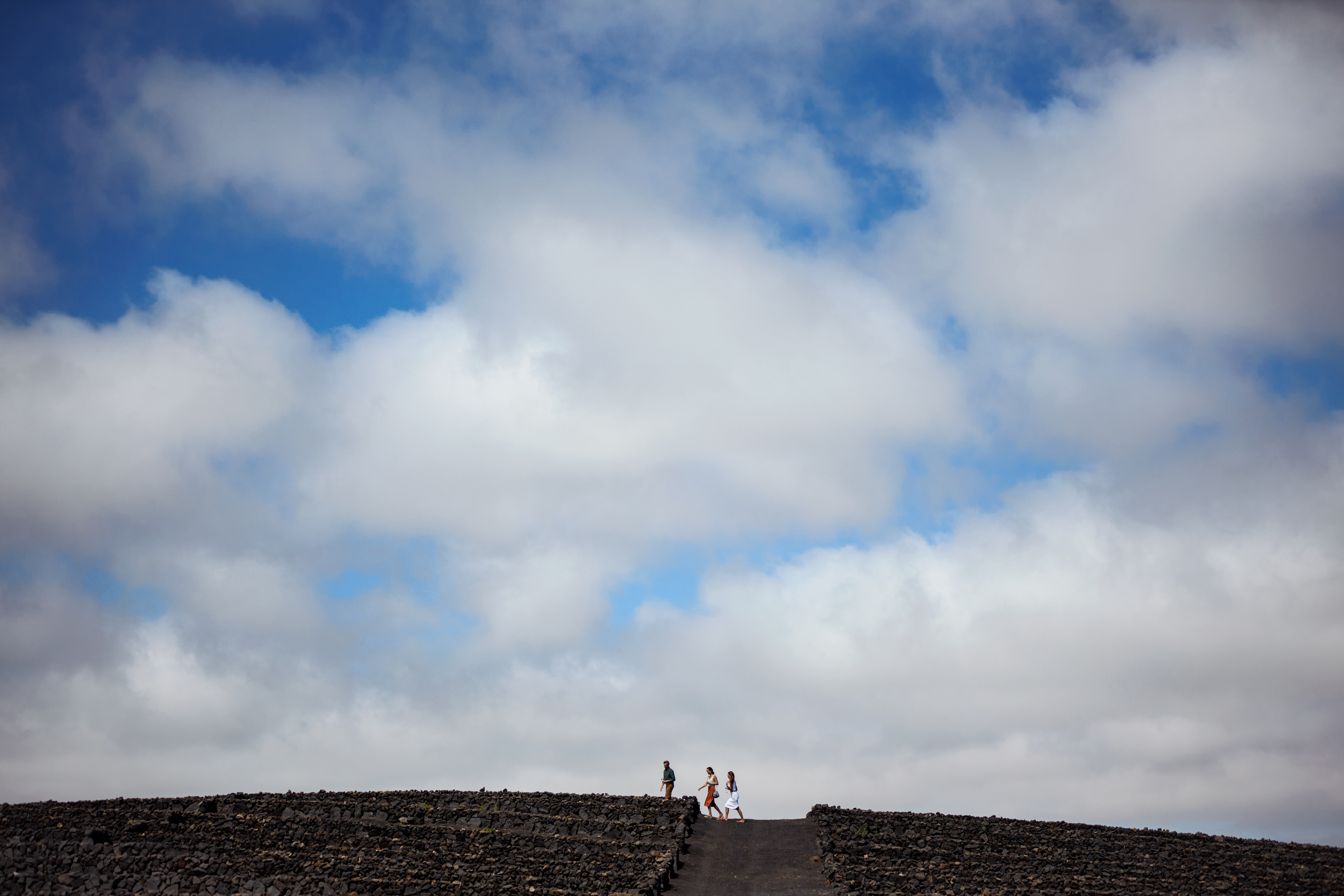 people walking up a hill