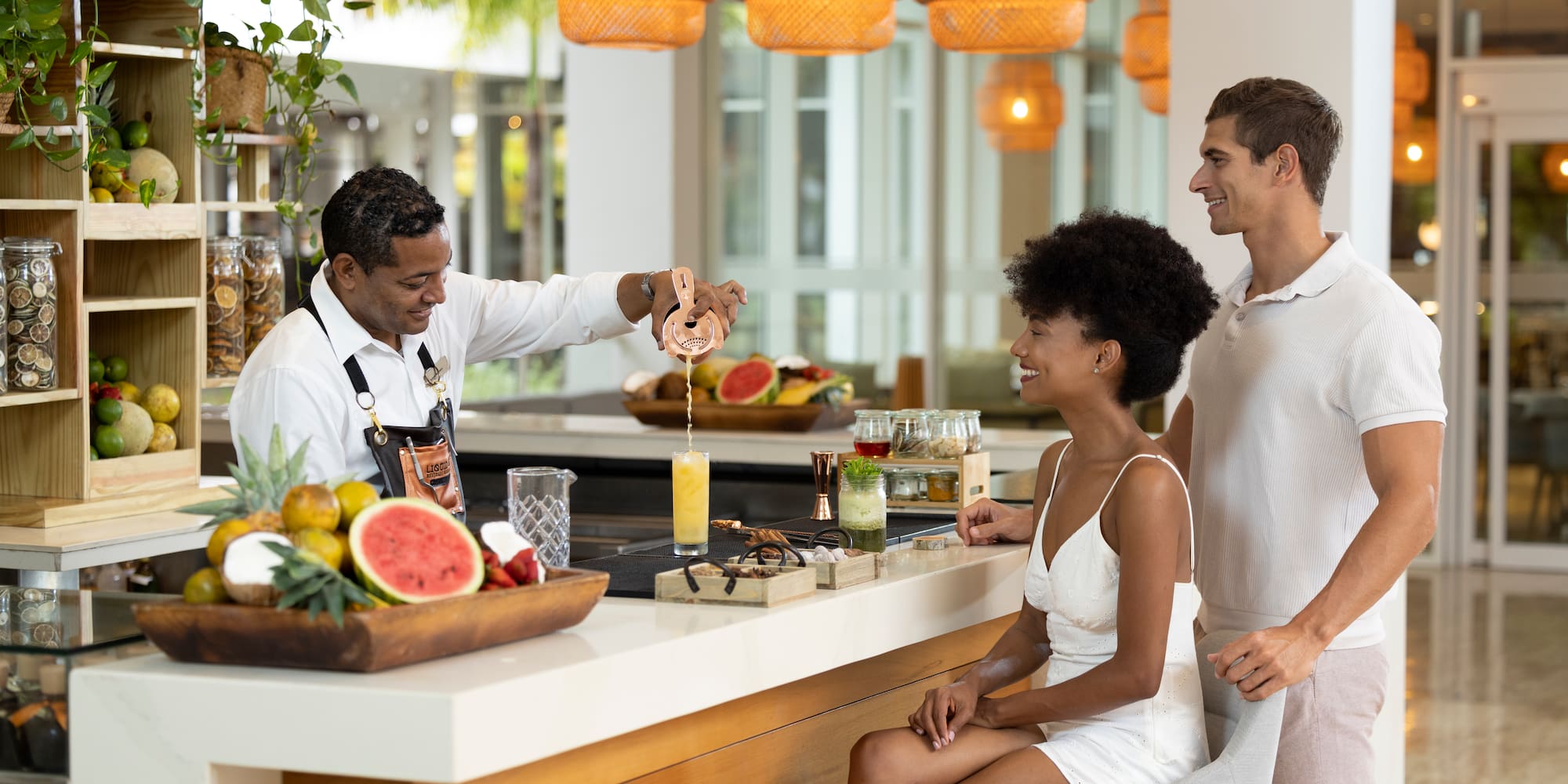 a man standing behind a counter with a woman in a white dress