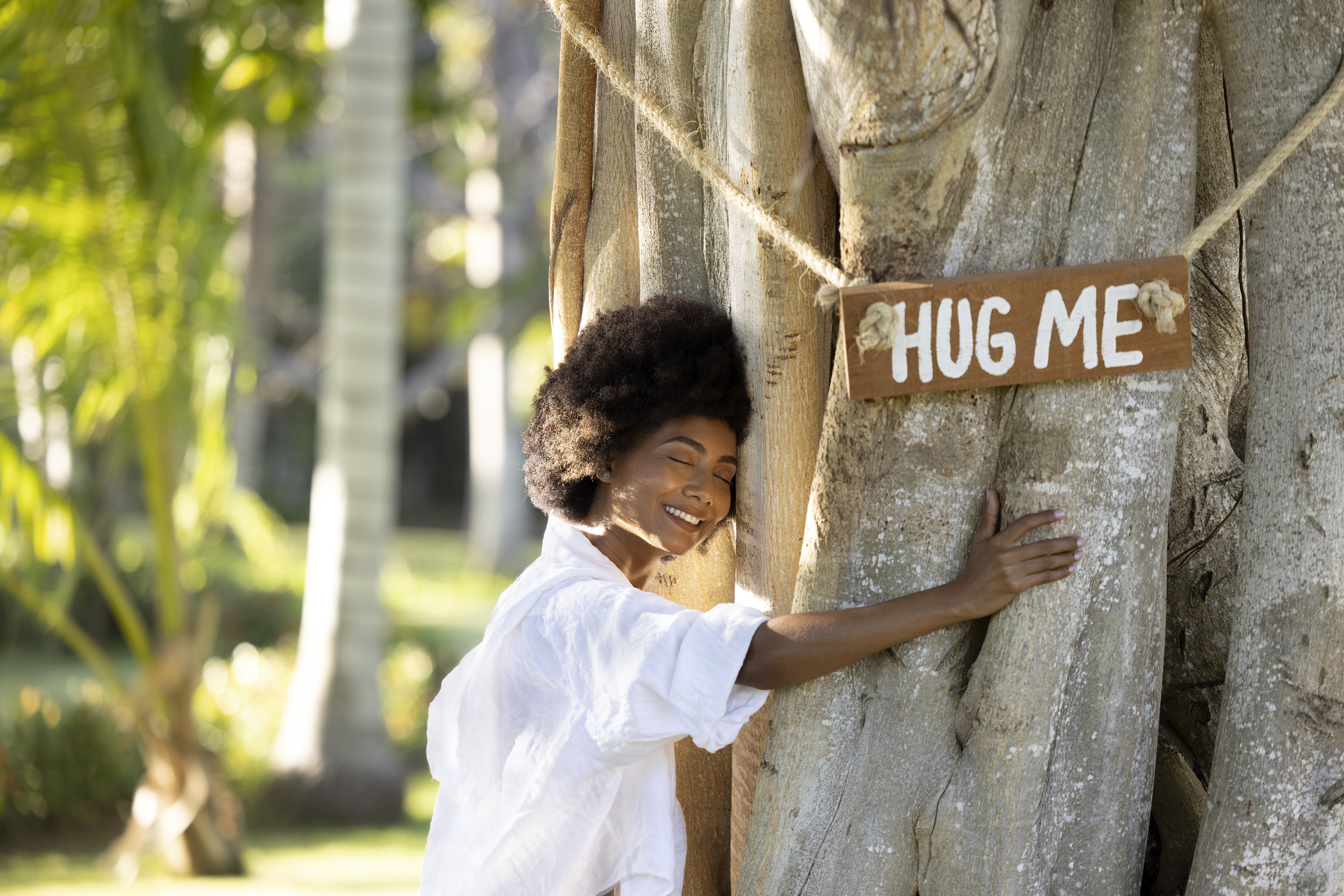 a woman hugging a tree
