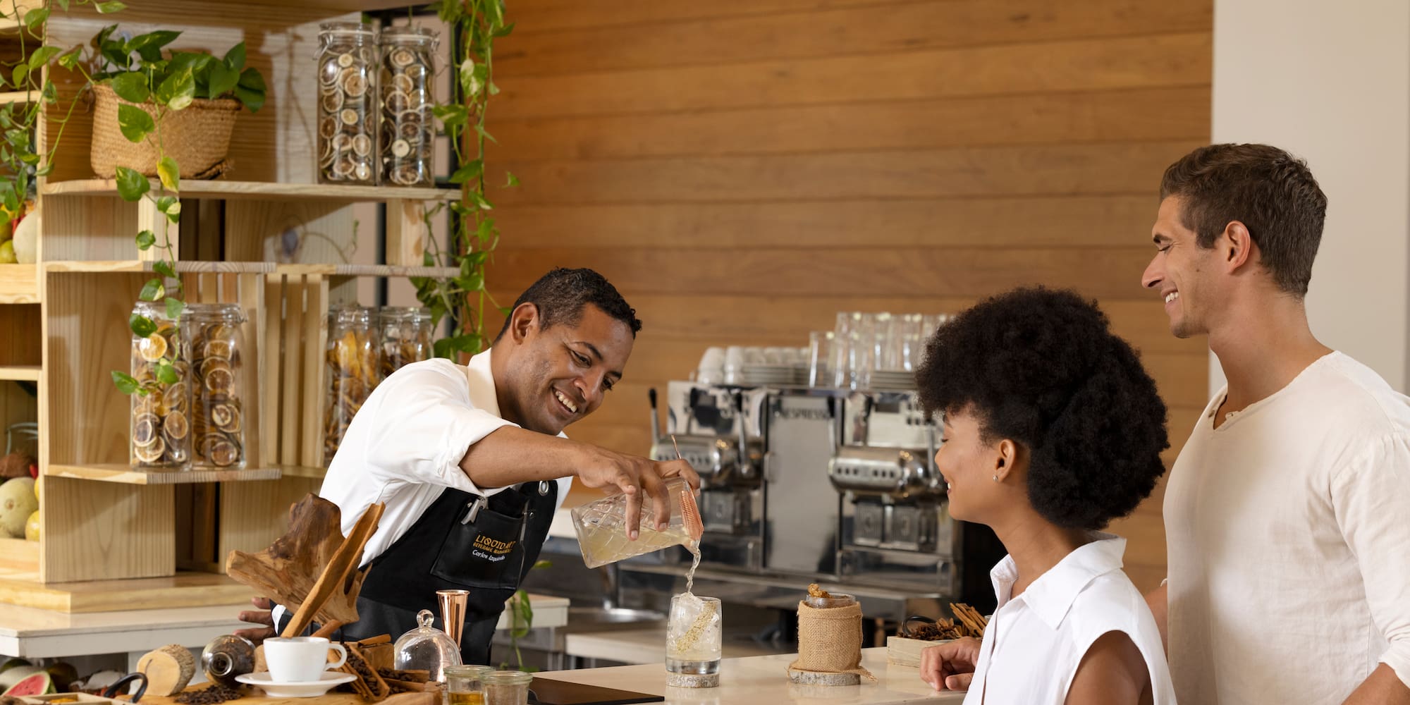 a man pouring water into a glass of liquid