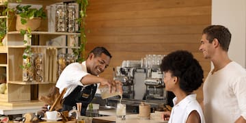 a man pouring water into a glass of liquid