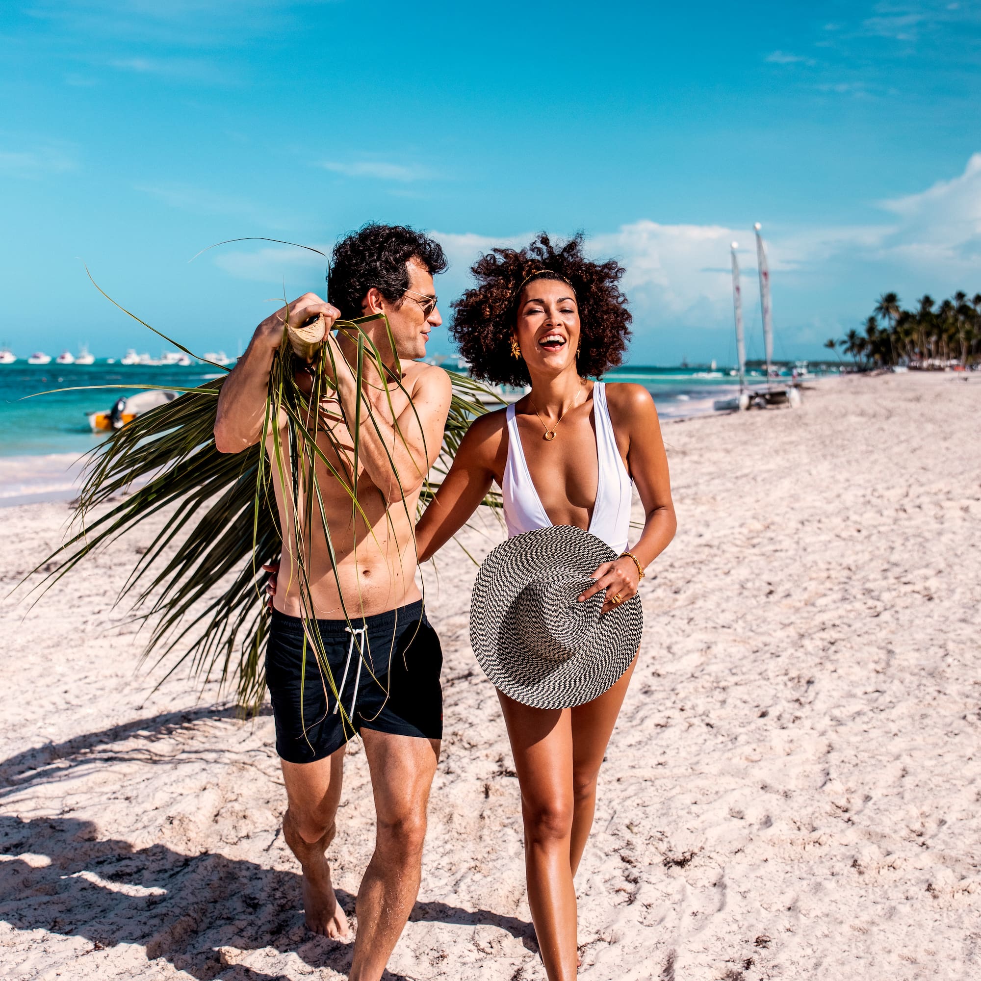 a man and woman walking on a beach