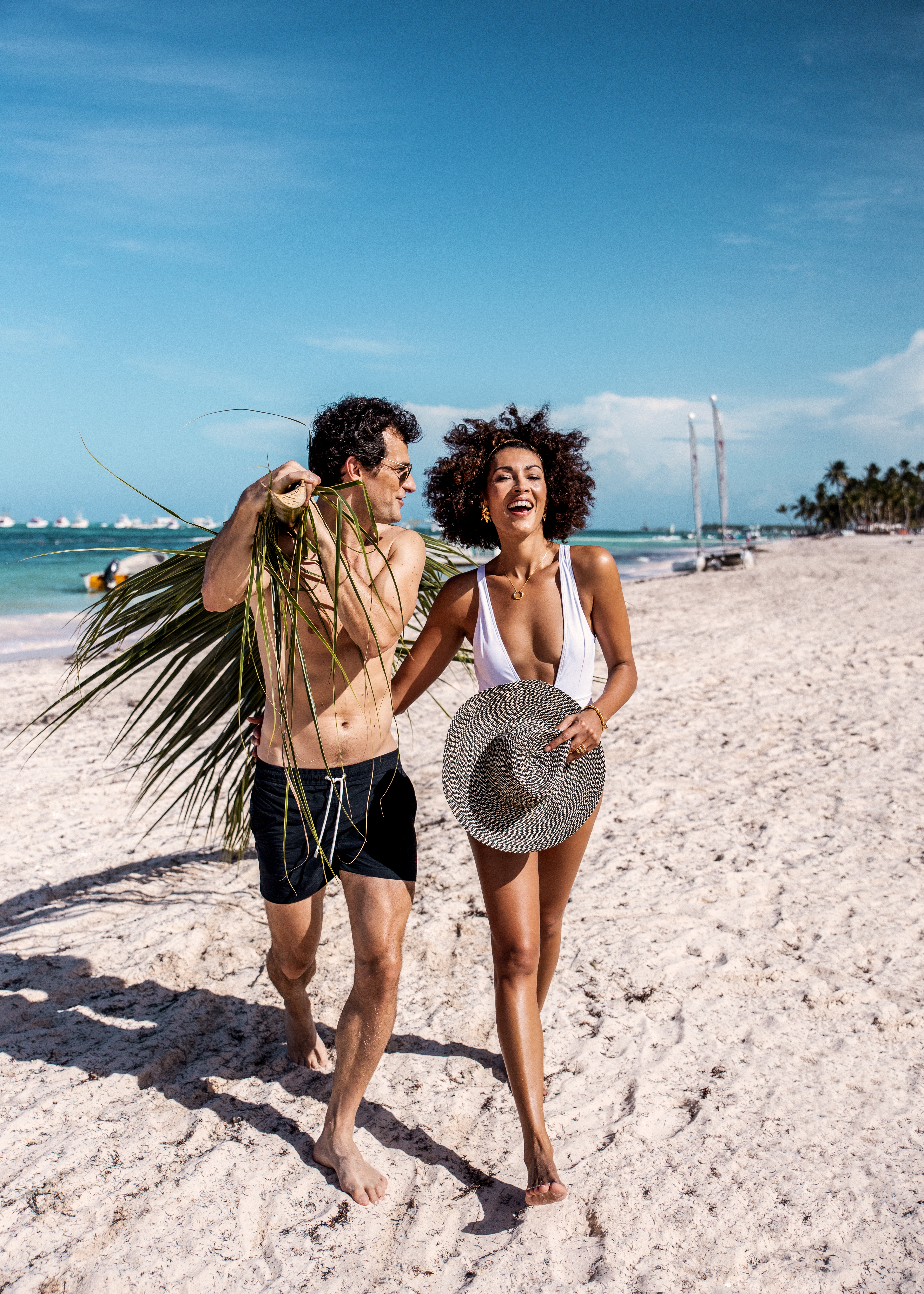 a man and woman walking on a beach