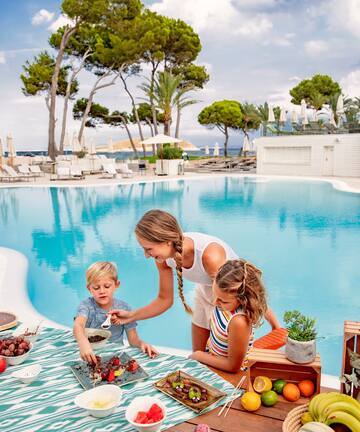 a woman and kids by a pool