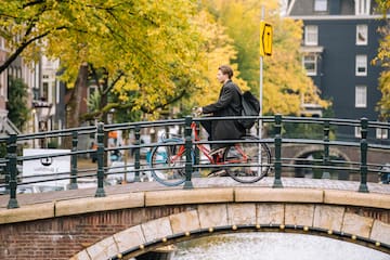 a man riding a bicycle on a bridge