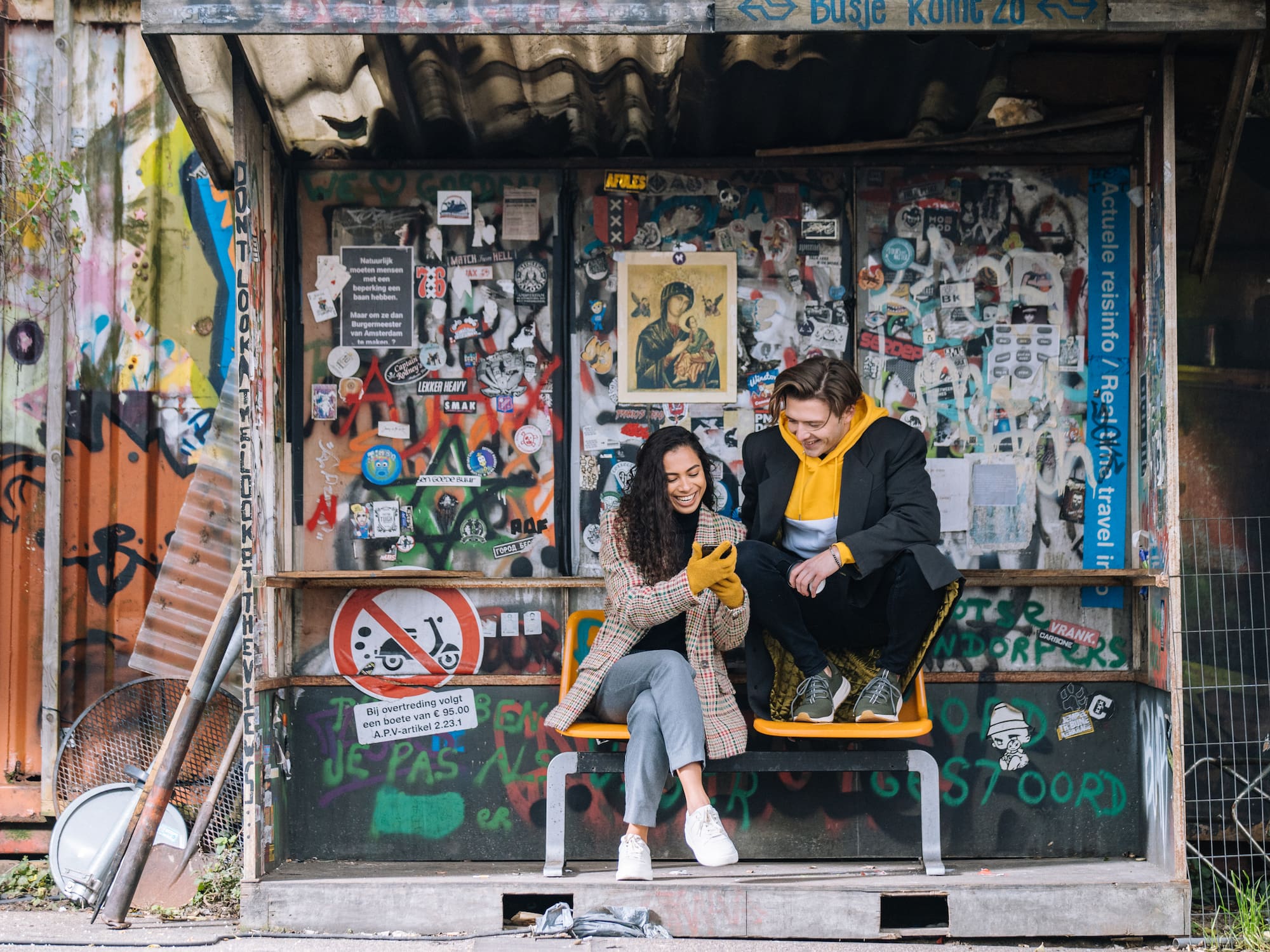 a man and woman sitting on a bench