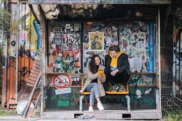 a man and woman sitting on a bench
