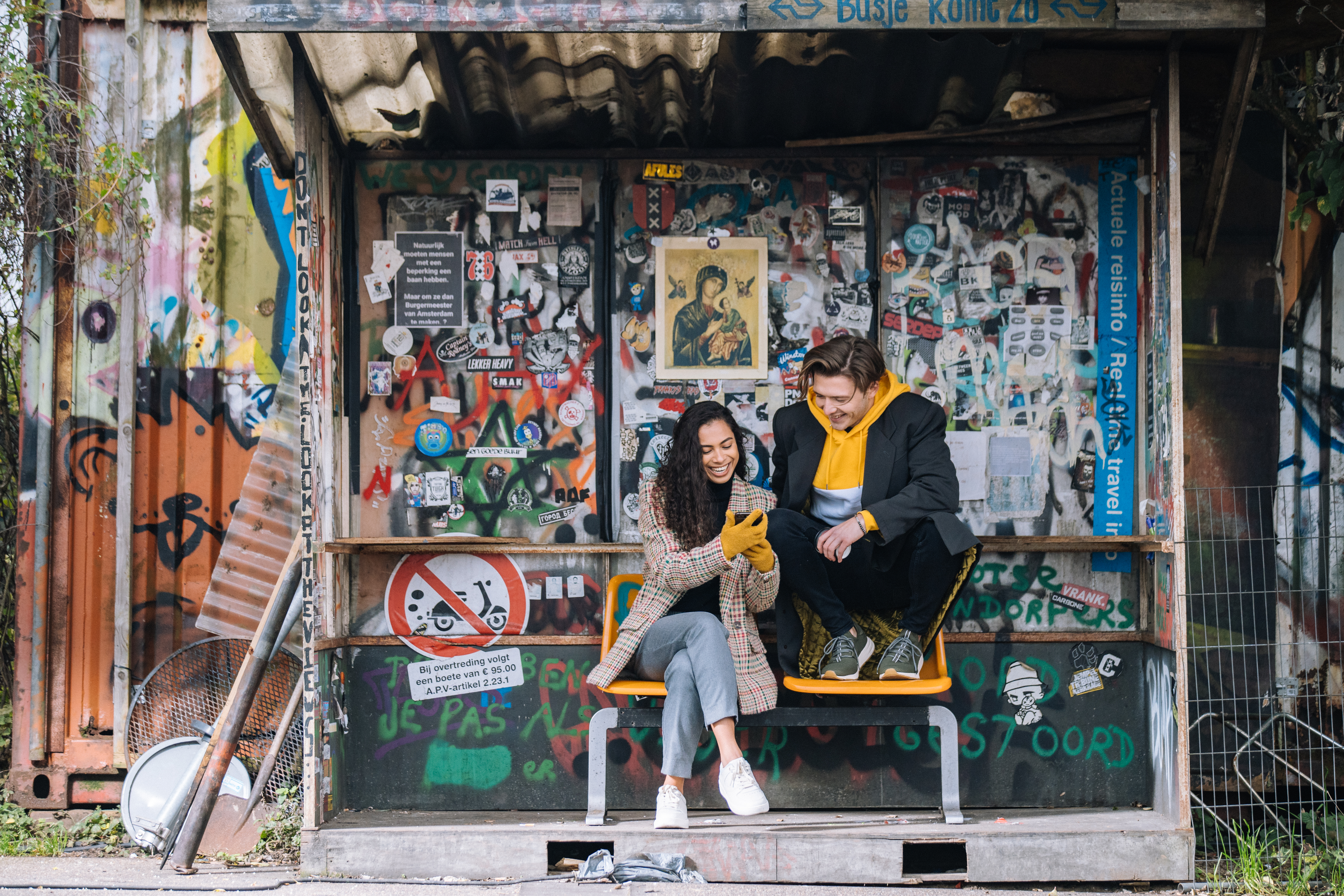 a man and woman sitting on a bench