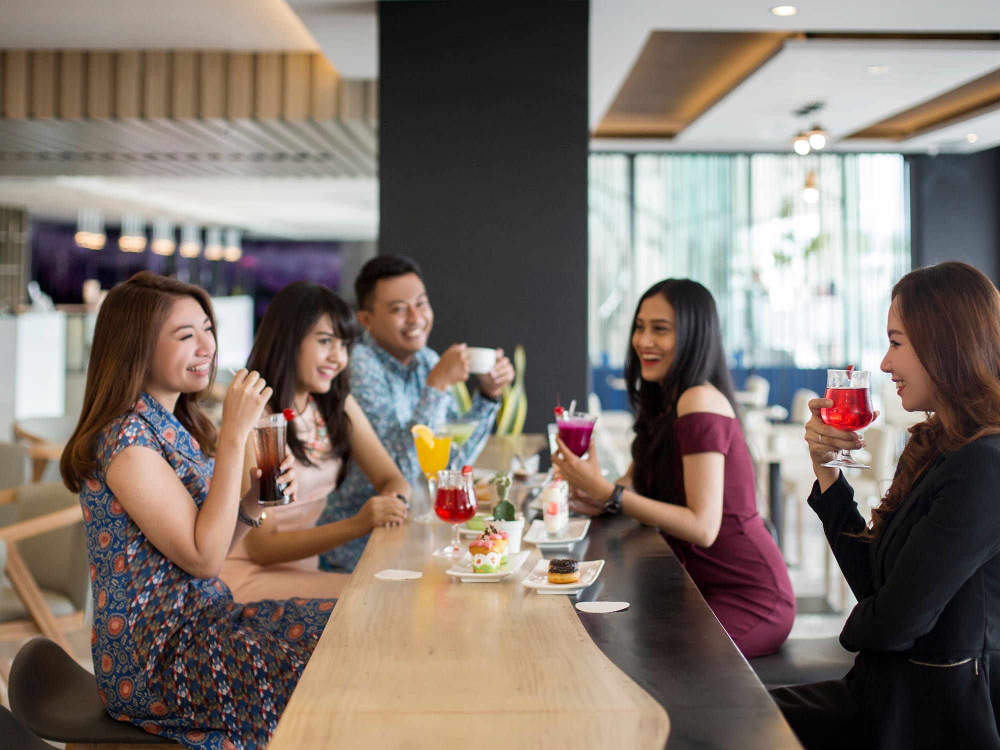 a group of people sitting at a bar