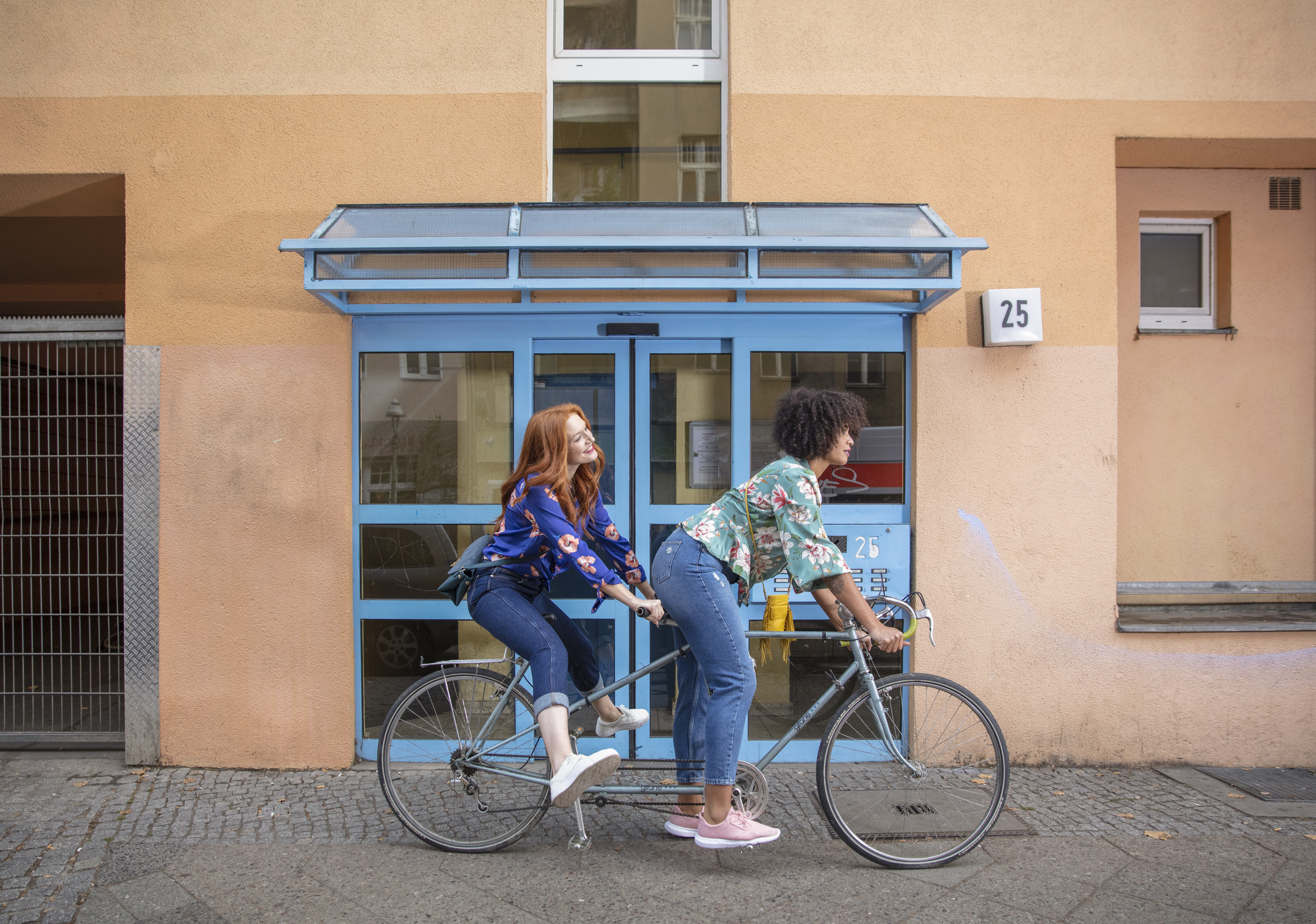 two women riding a bicycle