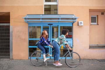 two women riding a bicycle