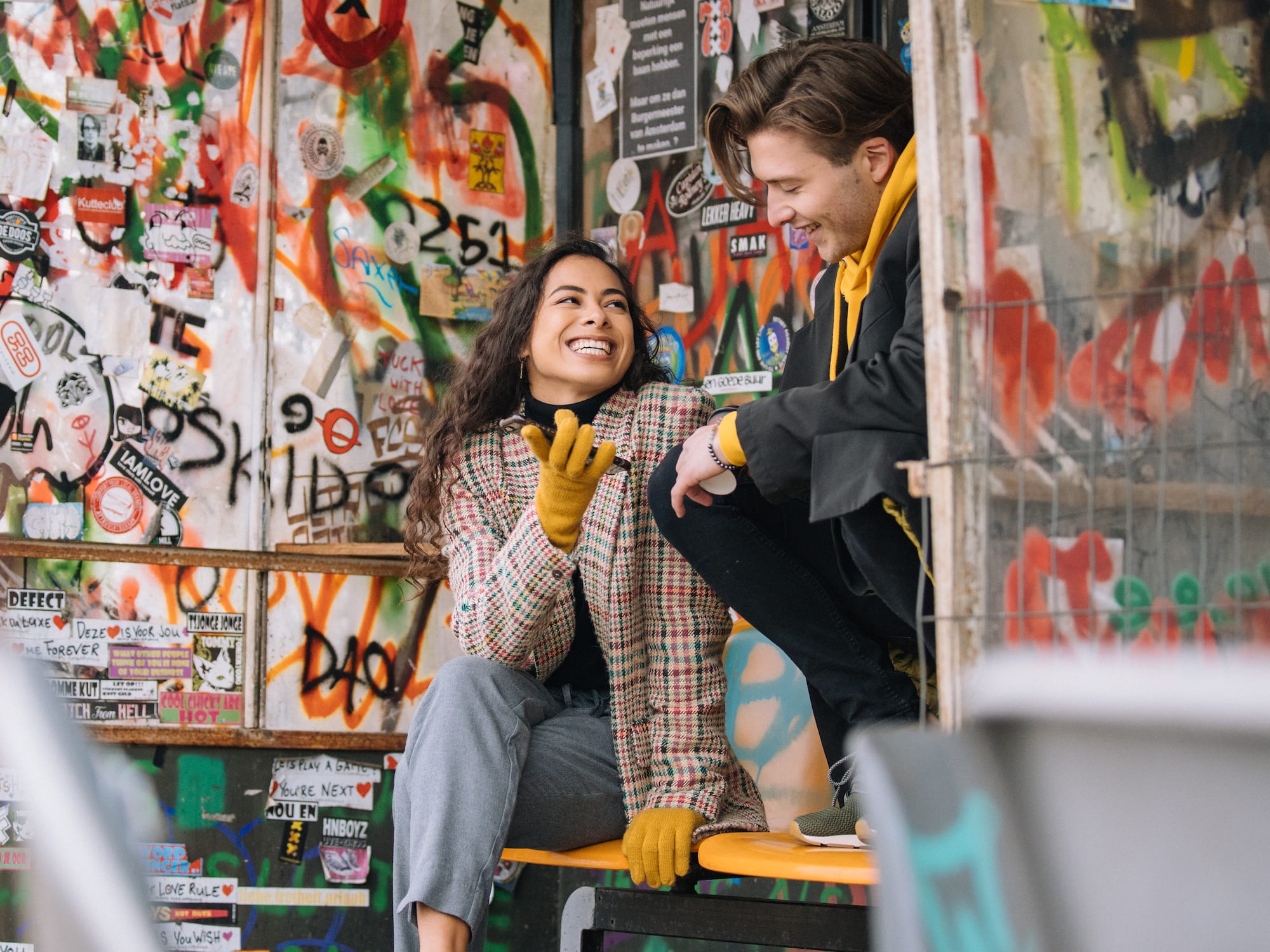 a man and woman sitting on a bench