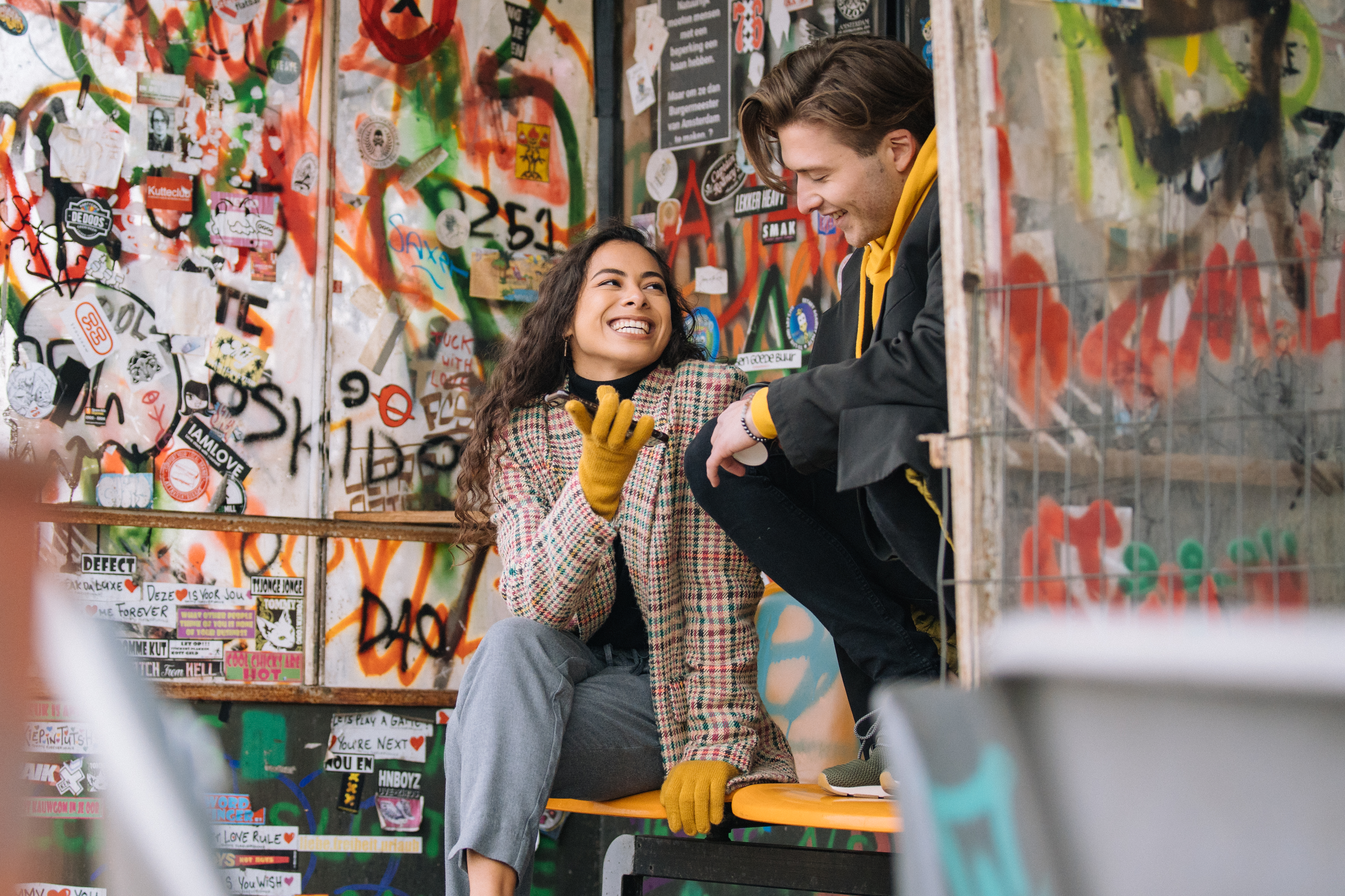 a man and woman sitting on a bench