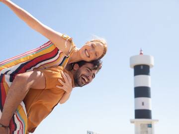 a man carrying a woman on his back