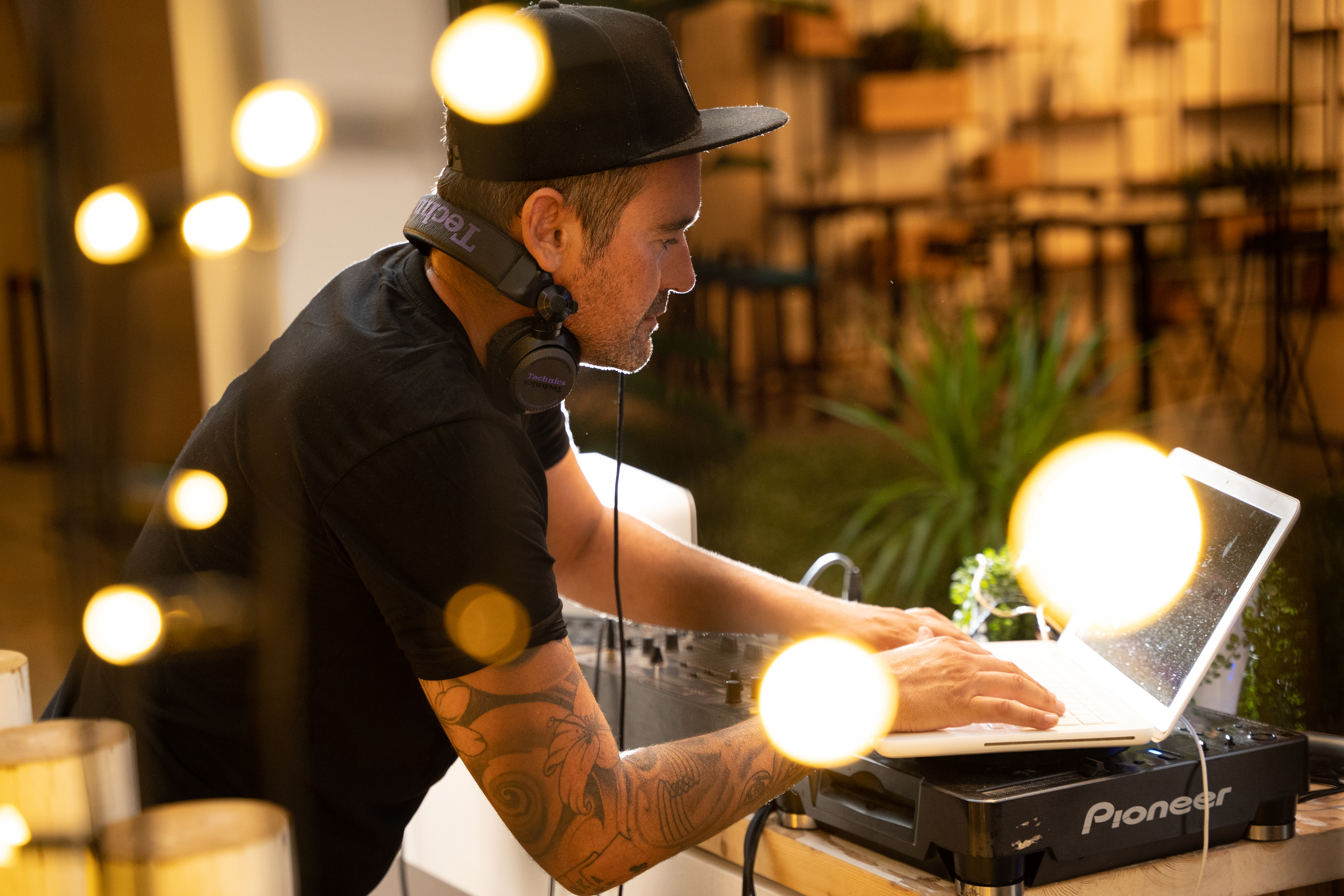 a man wearing a hat and headphones