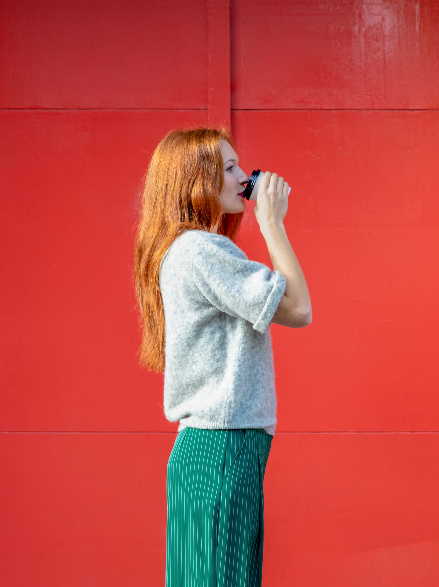 a woman drinking from a cup
